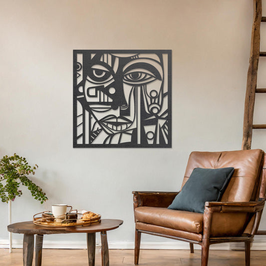 Wall art featuring an abstract face design with geometric patterns and intricate details, creating a modern and artistic composition. The piece is displayed on a neutral wall within rustic-modern decor, adding a bold and expressive focal point to the space.