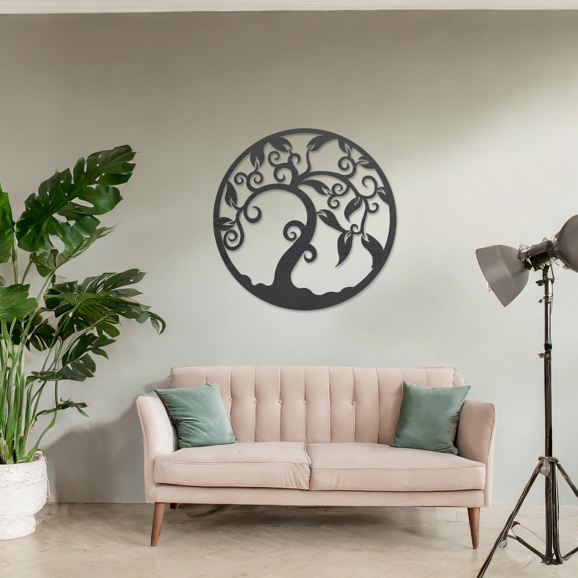 Wooden wall art design featuring a swirling tree with curved branches and leaves, framed in a circular shape, placed on a neutral wall within modern room decor. The design highlights elegant, flowing forms for a peaceful, organic look.