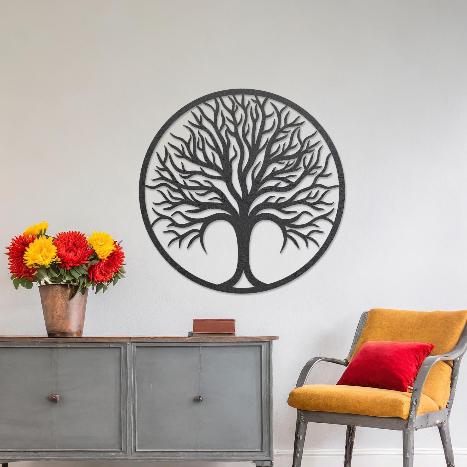 Circular wall art featuring a detailed tree design with spreading branches, symbolising life and growth. This piece is displayed on a neutral wall in a modern room, complementing the elegant and contemporary decor.