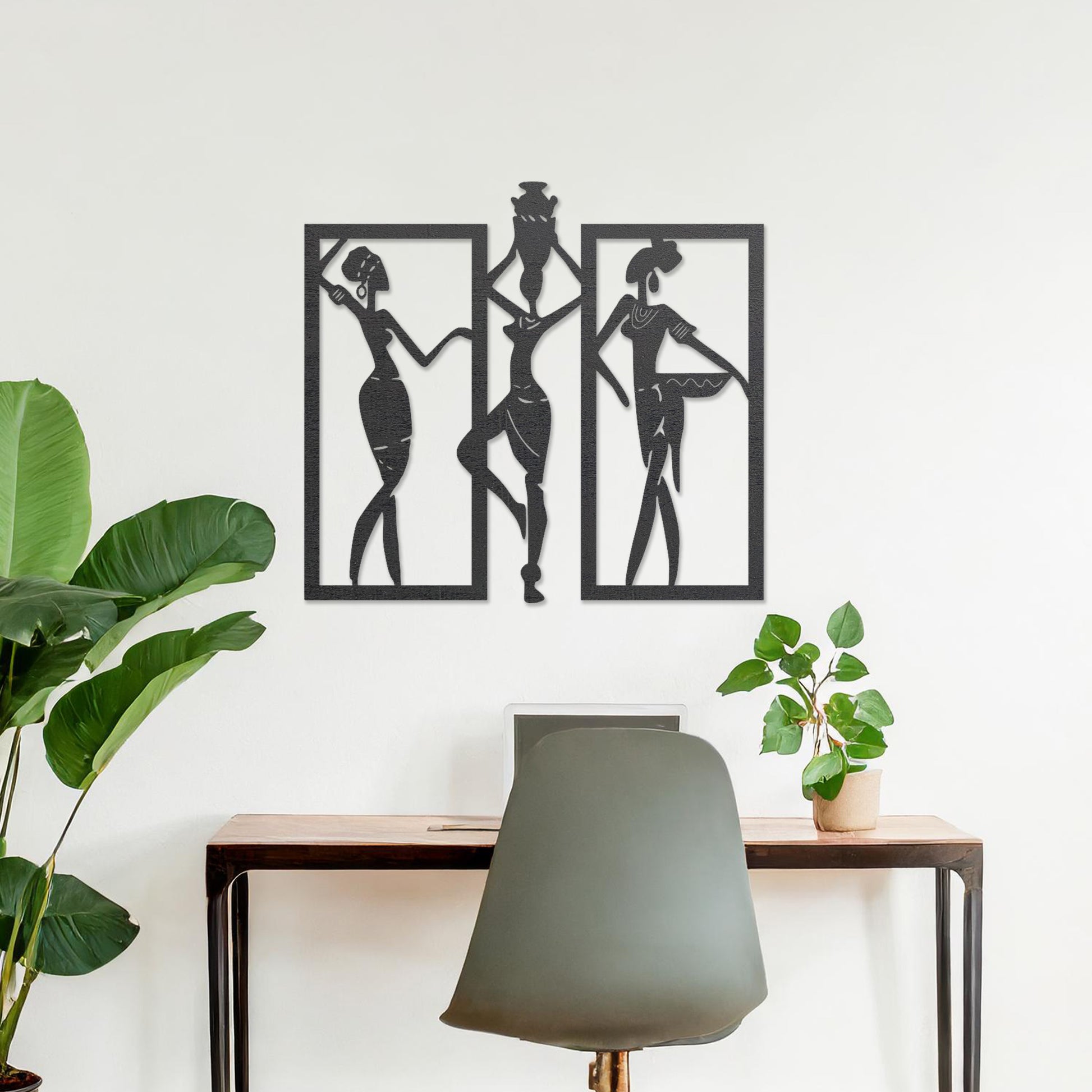 Wall art featuring a triptych design of abstract figures in dynamic poses, framed within rectangular panels. The artwork is displayed on a neutral wall within modern decor, adding an artistic and cultural touch to the space.