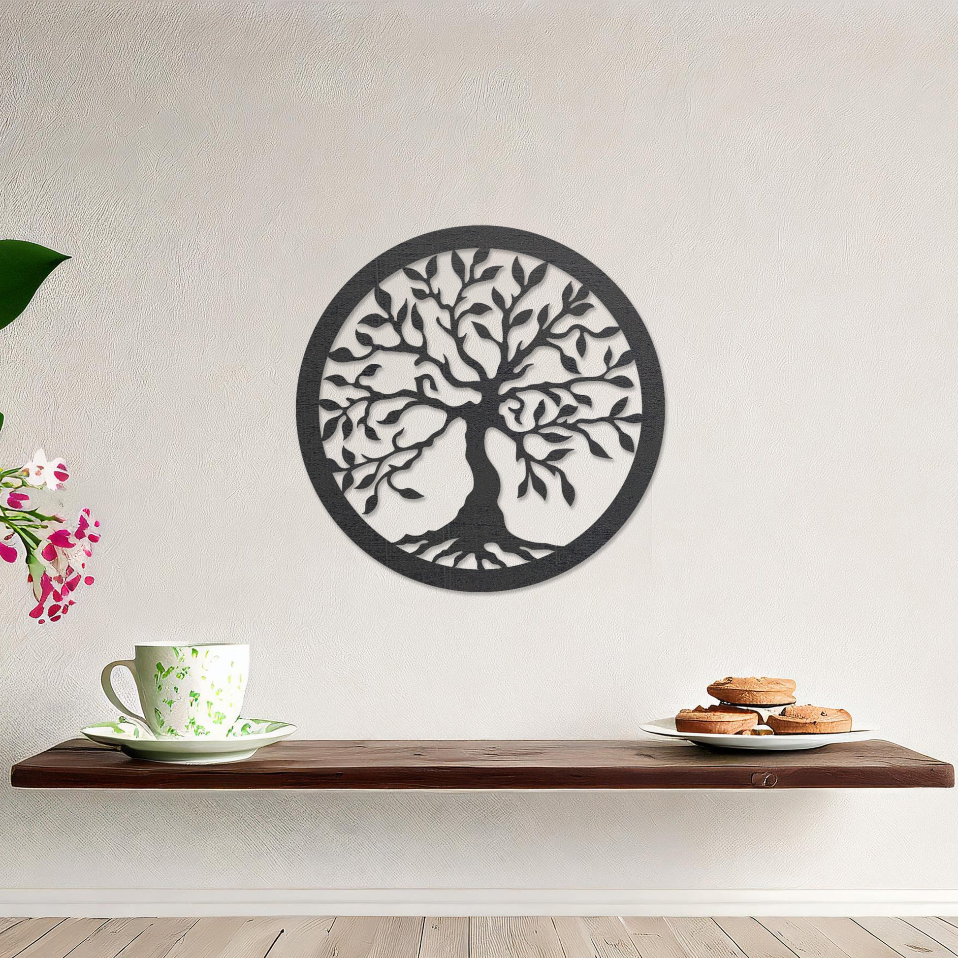 Round wooden wall art featuring an intricately designed tree with sprawling branches and delicate leaves, placed on a neutral wall within a modern setting. The art adds a natural and stylish focal point to the room.