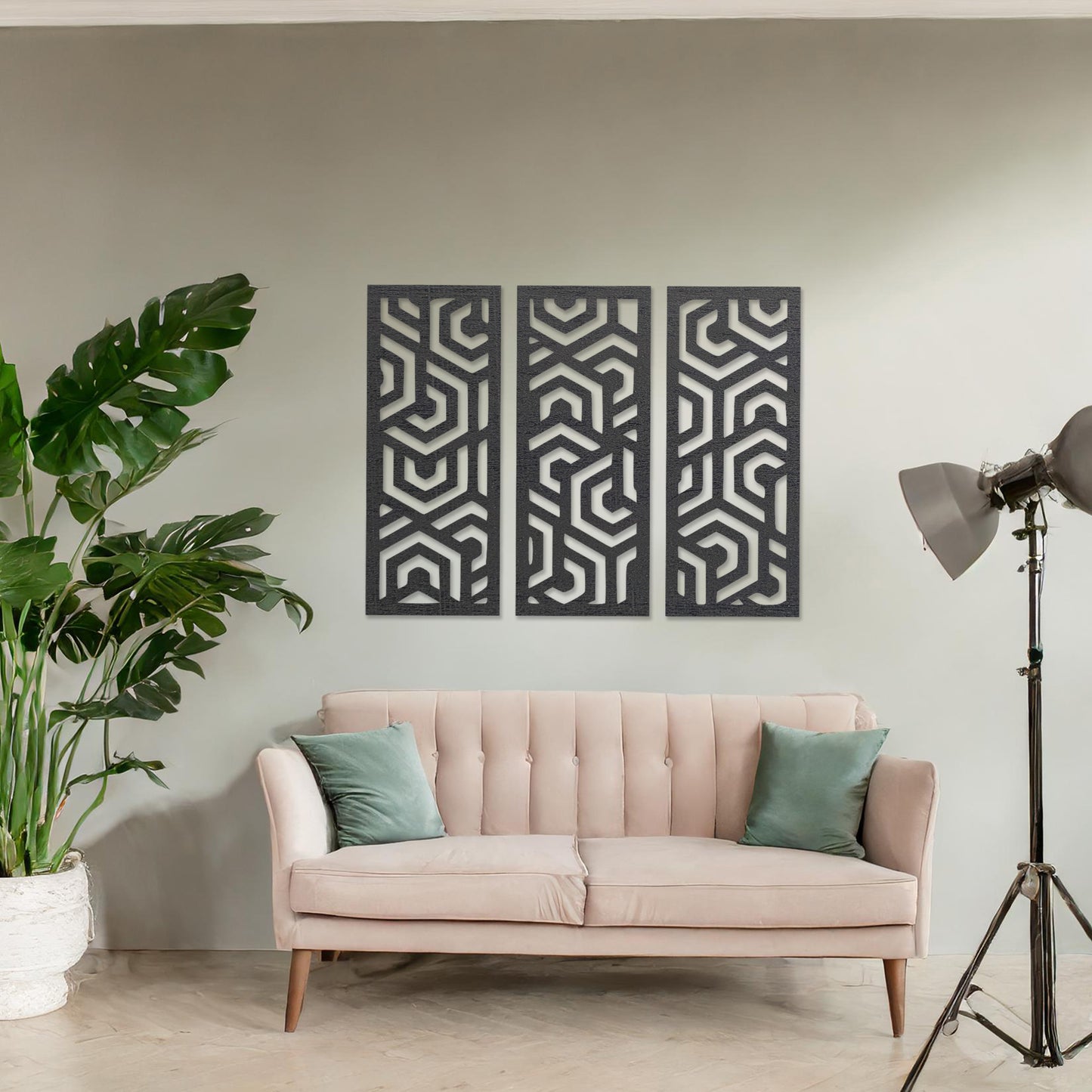 Wooden wall art featuring a three-panel design with intricate geometric patterns. The artwork is displayed on a neutral wall within modern room decor, highlighting its bold and symmetrical design.
