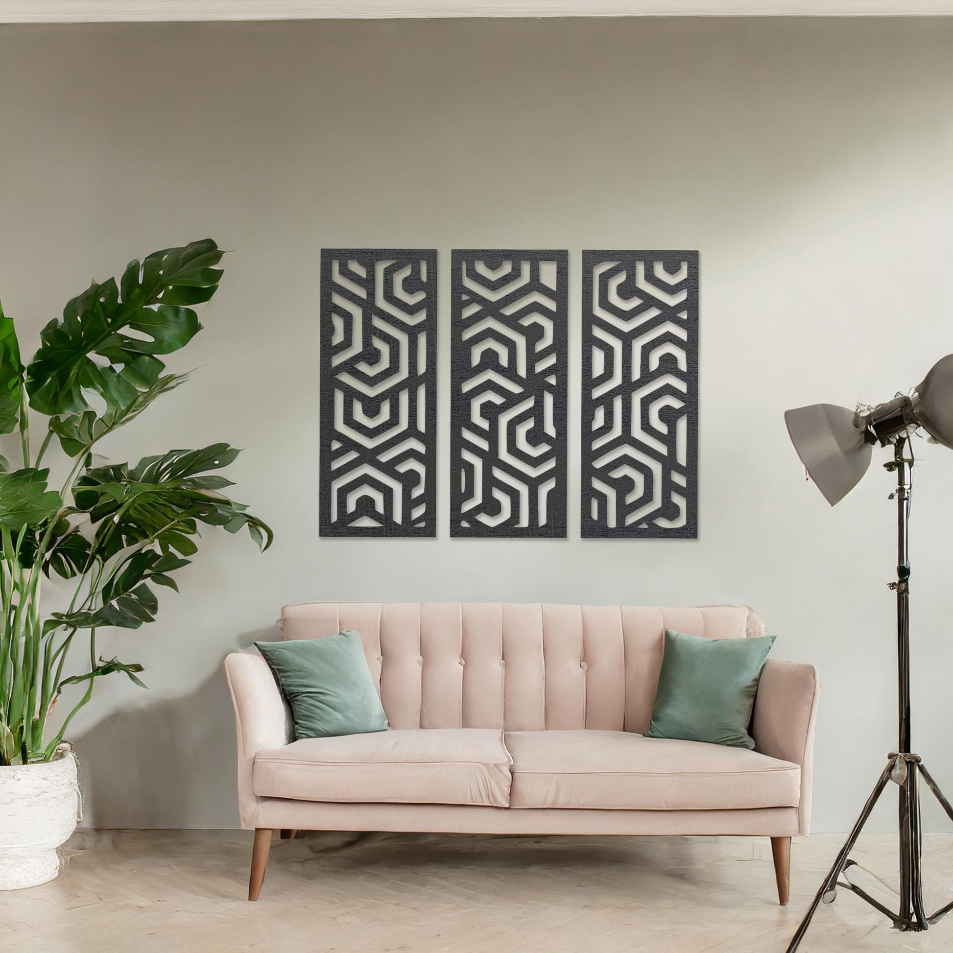 Wooden wall art featuring a three-panel design with intricate geometric patterns. The artwork is displayed on a neutral wall within modern room decor, highlighting its bold and symmetrical design.