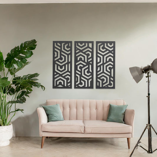 Wooden wall art featuring a three-panel design with intricate geometric patterns. The artwork is displayed on a neutral wall within modern room decor, highlighting its bold and symmetrical design.