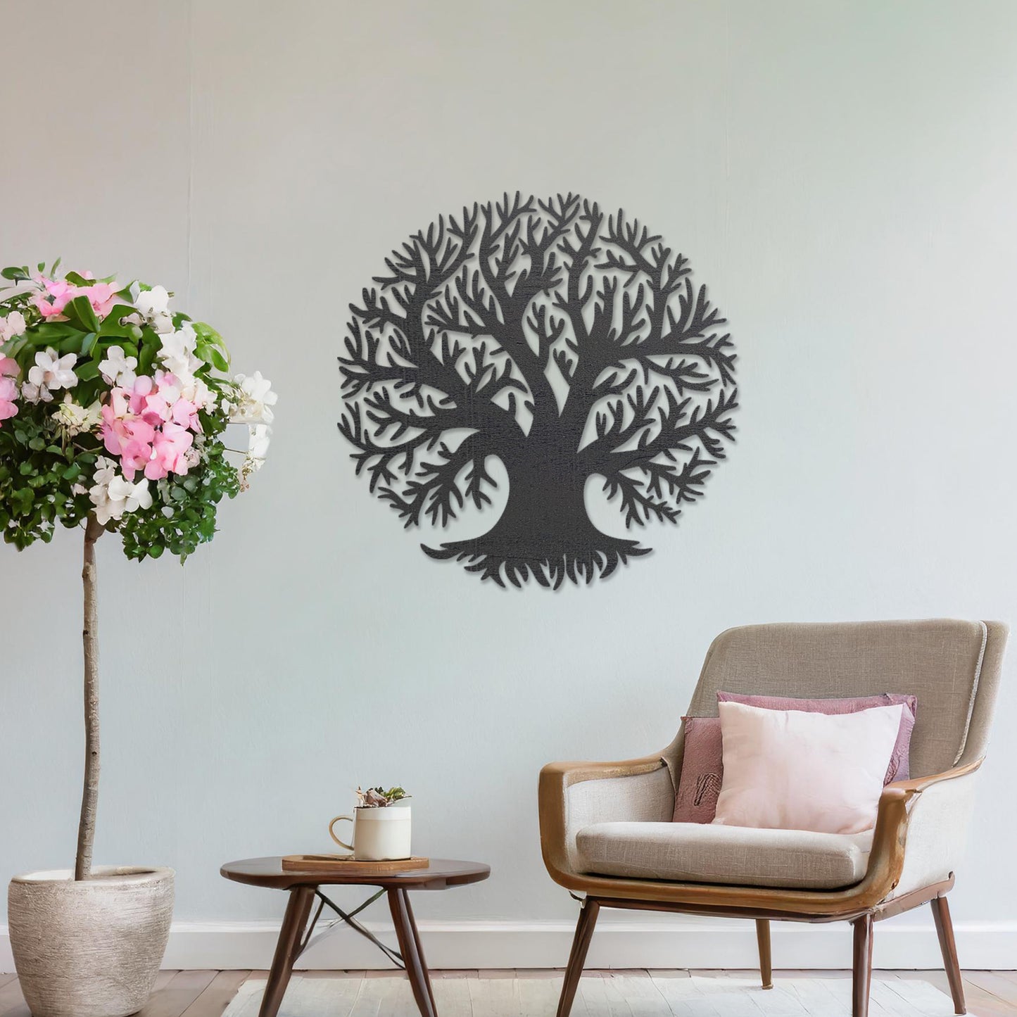 Wooden wall art featuring a circular tree design with detailed branches, displayed on a neutral wall within modern room decor, emphasising its intricate craftsmanship and natural theme.