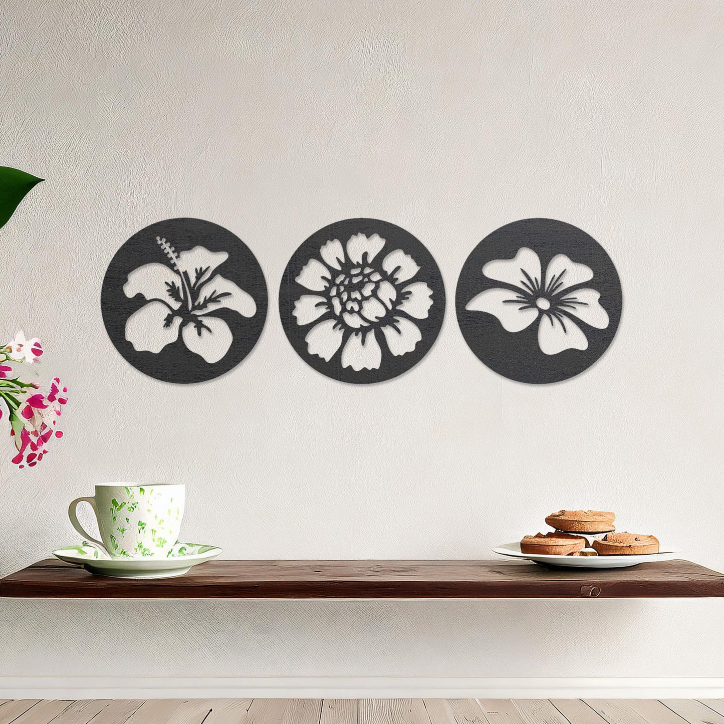 Wall art featuring a set of three circular panels, each showcasing a distinct floral design with intricate cut-out details. The artwork is displayed on a neutral wall within modern decor, adding a charming and decorative touch to the space.
