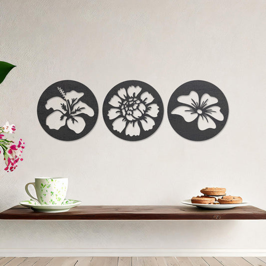 Wall art featuring a set of three circular panels, each showcasing a distinct floral design with intricate cut-out details. The artwork is displayed on a neutral wall within modern decor, adding a charming and decorative touch to the space.