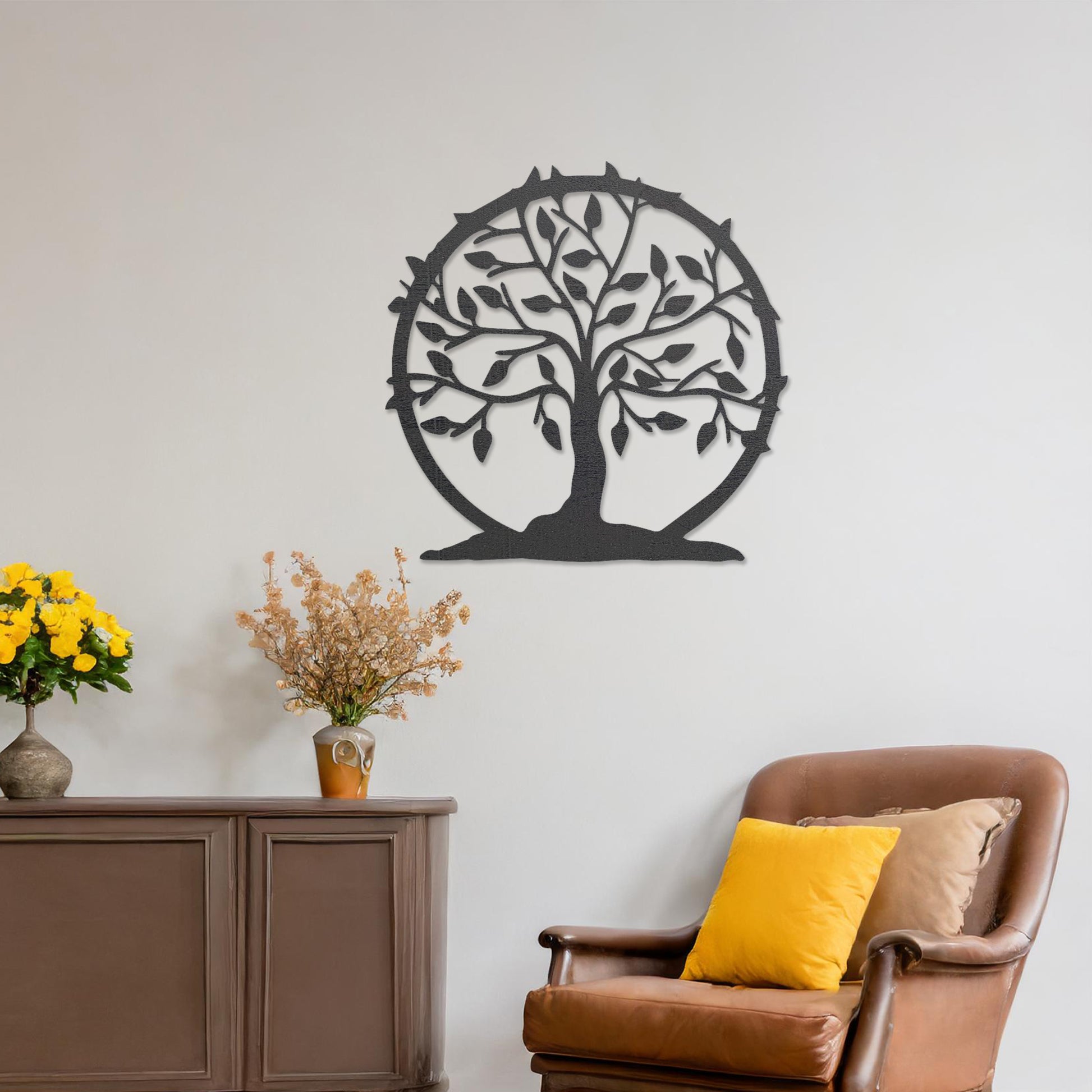 Wooden wall art featuring a circular tree design with branches, leaves, and a border of thorns. The artwork is displayed on a neutral wall within modern room decor, emphasising its natural and symbolic charm.