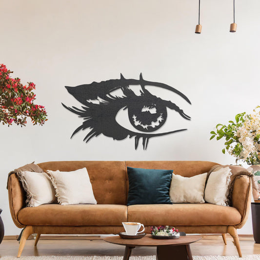 Wooden wall art featuring a stylised eye design with intricate detailing of lashes and bold lines. The artwork is displayed on a neutral wall within modern room decor, emphasising its artistic and striking pattern.