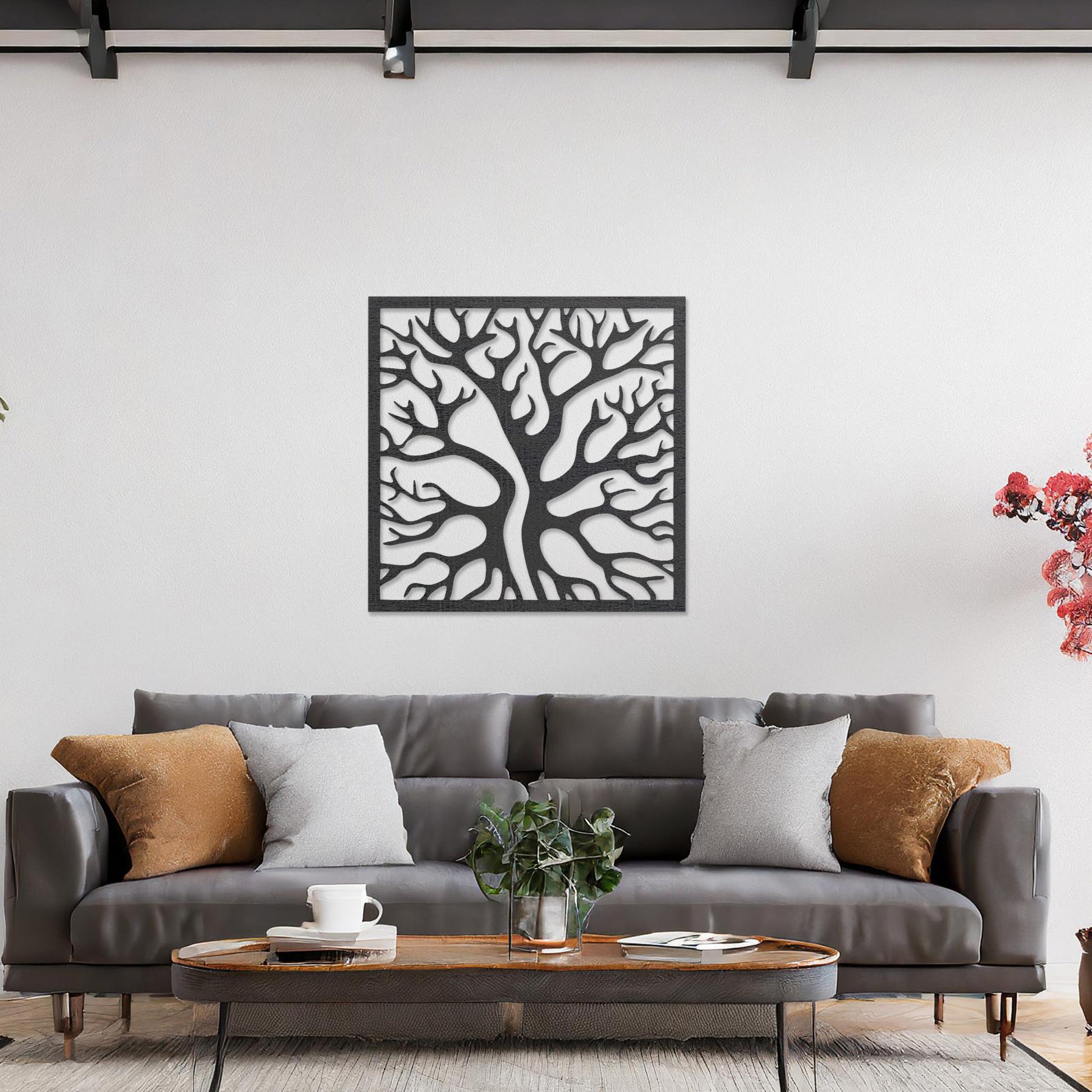 Square wall art featuring a stylised tree with intertwining branches, showcasing a modern and organic design. The artwork is displayed on a neutral wall in a contemporary living room with a sleek sofa and complementary decor.
