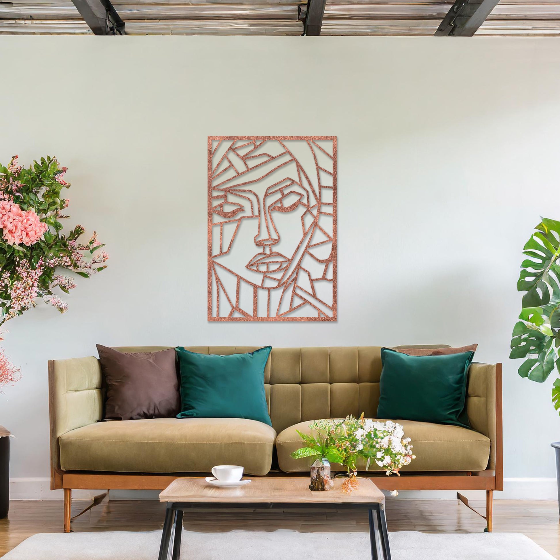 A rectangular wall art piece featuring an abstract face design composed of geometric shapes and clean lines. The artwork is displayed on a neutral wall in a contemporary living room, 
