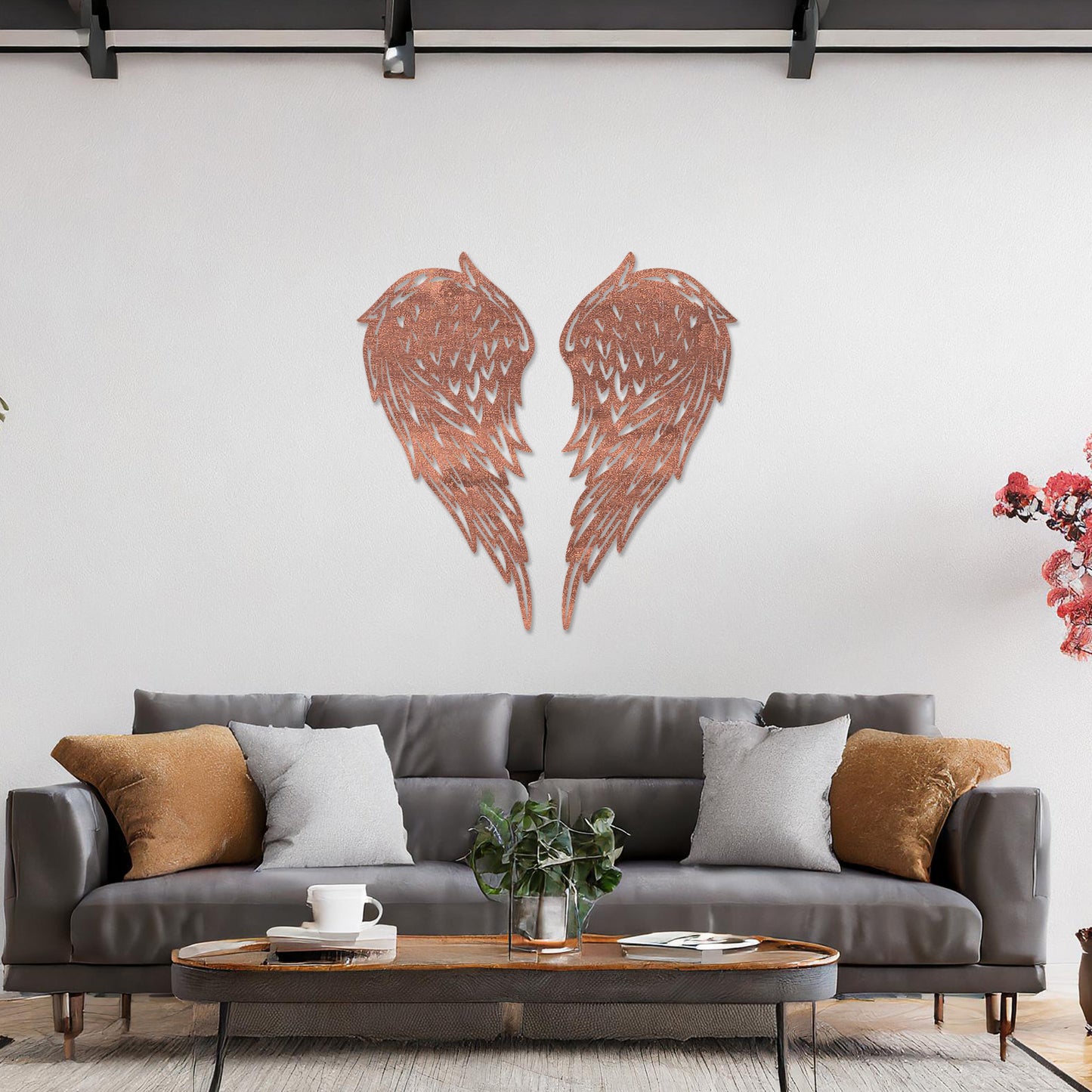 Wall art showcasing intricately designed angel wings with detailed feather patterns, displayed on a neutral wall in a modern living room. The piece adds a sense of elegance and serenity to the contemporary decor.