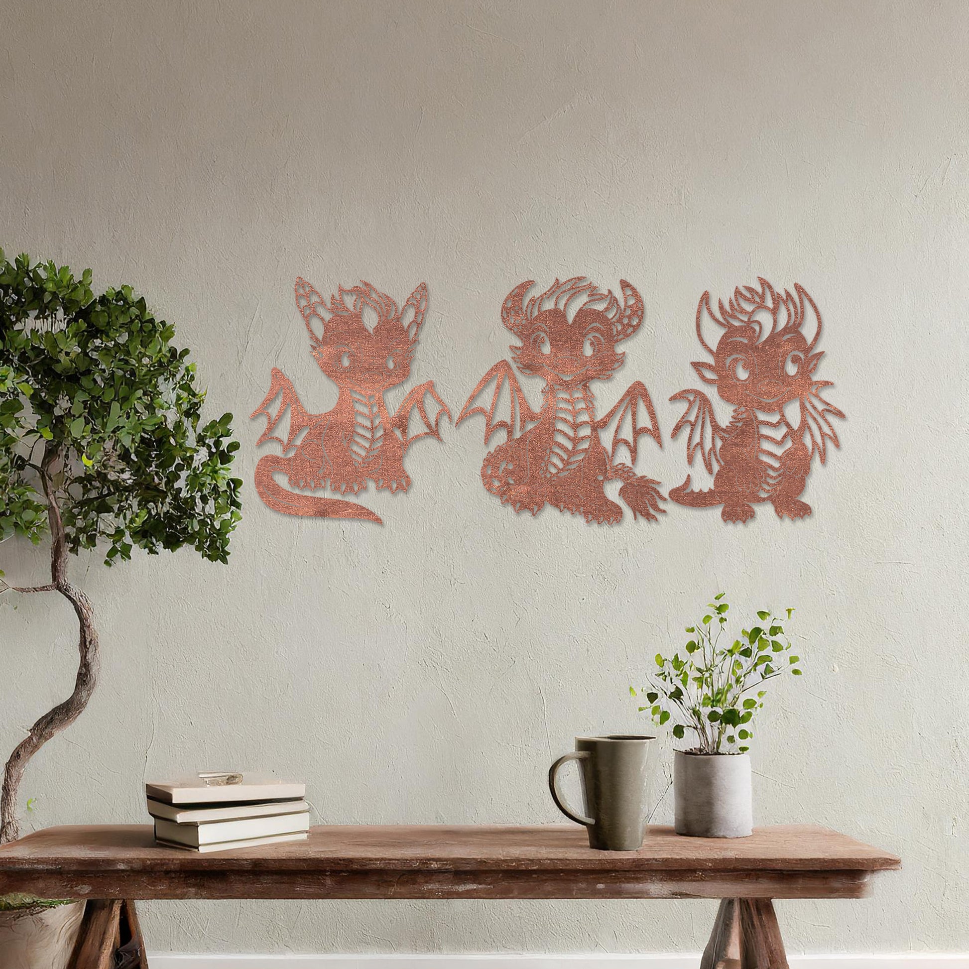 Wooden wall art design featuring three playful dragon characters, each with different poses and expressions, placed on a neutral wall within modern room decor. The design brings whimsy and charm with detailed features and lively energy.