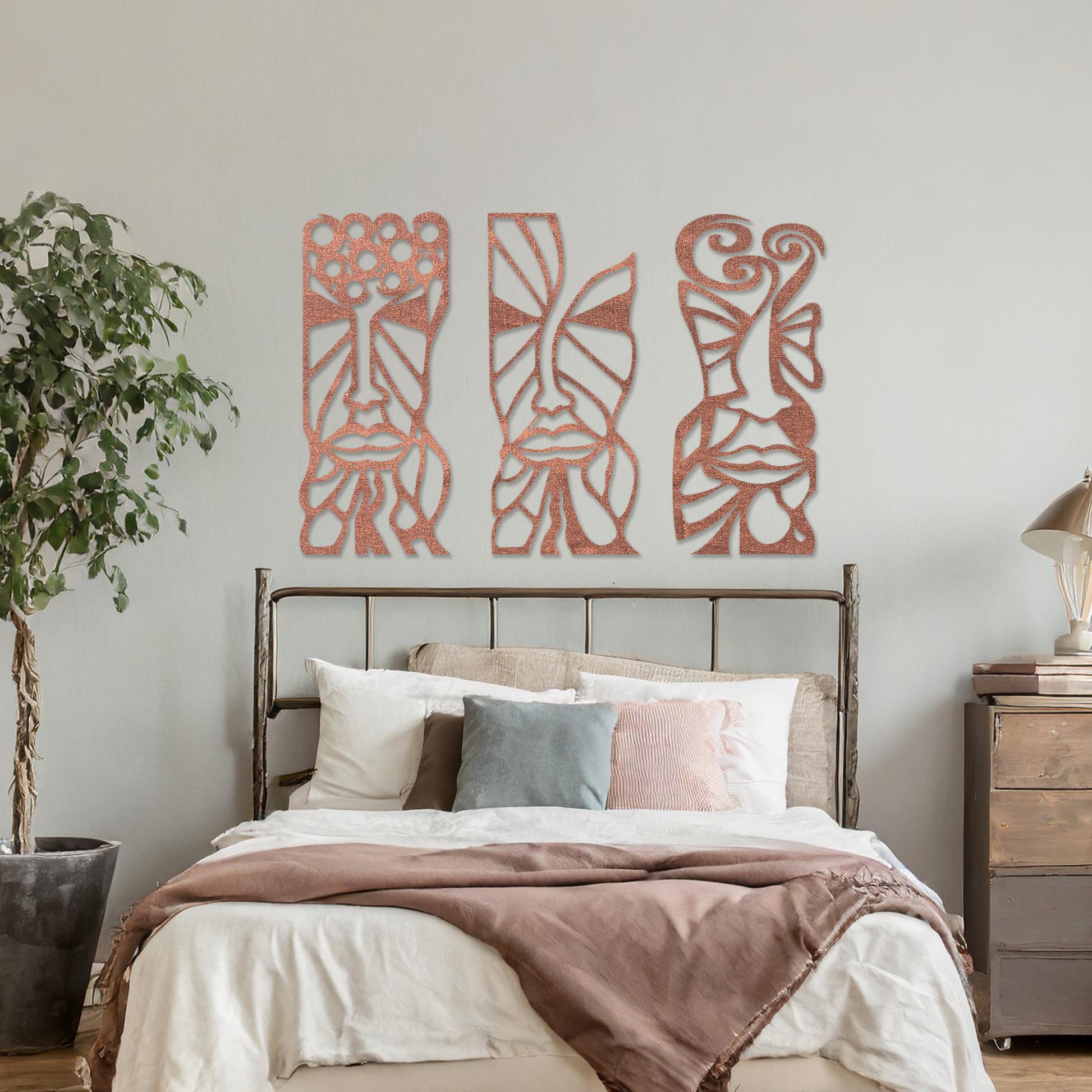 Wooden wall art set featuring three abstract face designs with intricate geometric and flowing patterns, displayed on a neutral wall within modern room decor, highlighting their artistic and contemporary appeal.