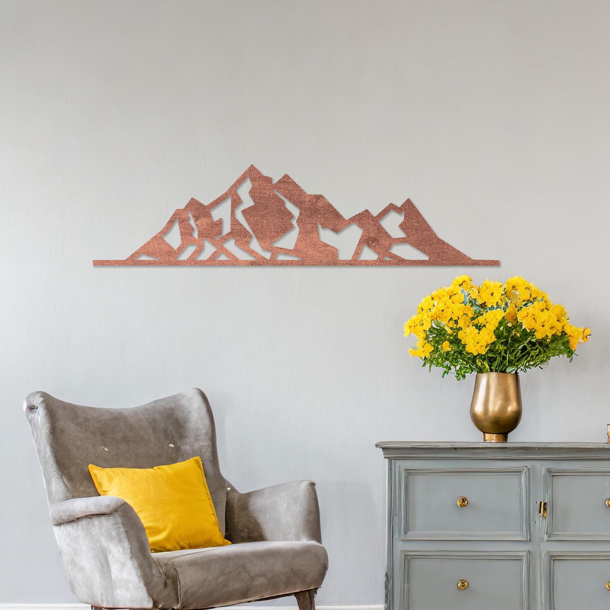 Wall art featuring a minimalist mountain range design with sharp geometric peaks. The piece is displayed on a neutral wall within modern decor, adding a natural and contemporary accent to the space.