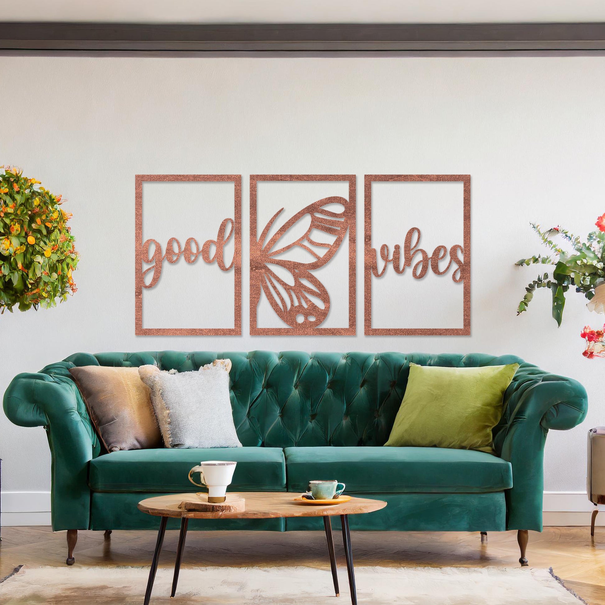 Wooden wall art featuring a three-panel design with the phrase "good vibes" and a butterfly motif in the centre. The artwork is placed on a neutral wall in modern room decor, highlighting its uplifting design.
