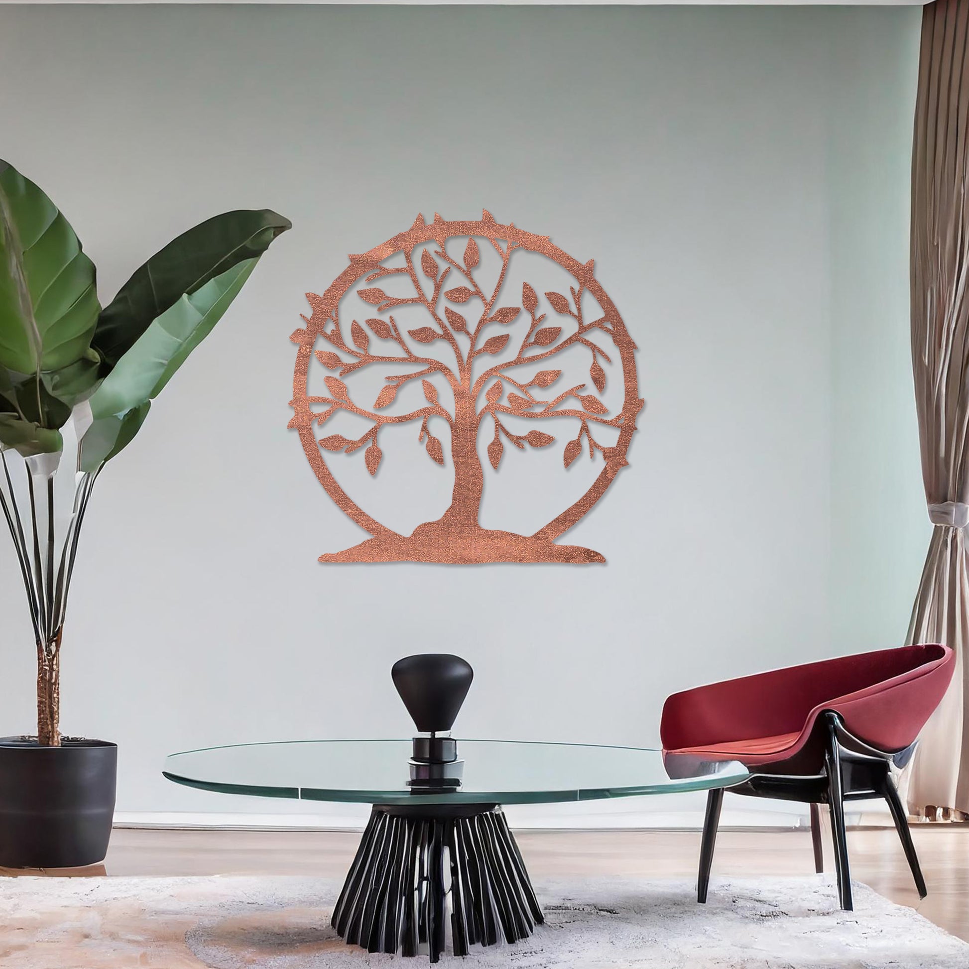 Wooden wall art featuring a circular tree design with branches, leaves, and a border of thorns. The artwork is displayed on a neutral wall within modern room decor, emphasising its natural and symbolic charm.