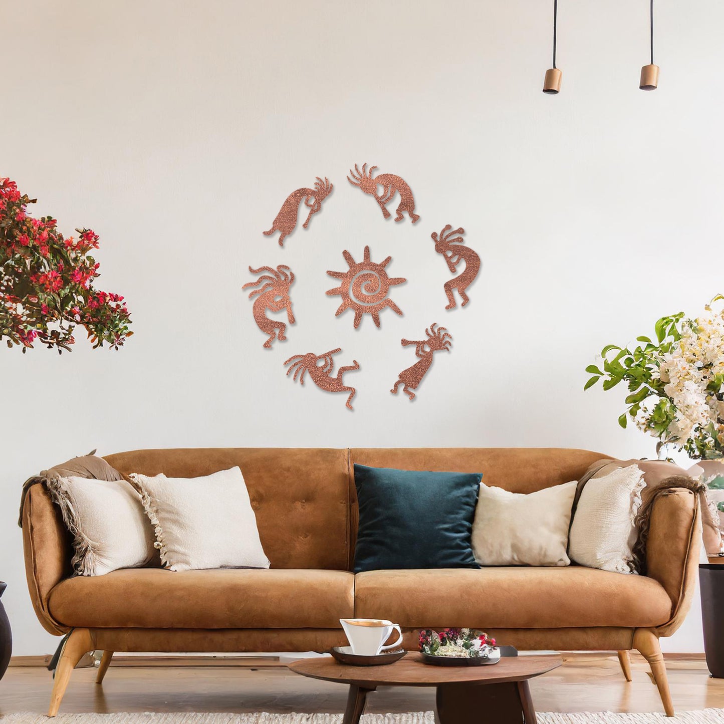 Wooden wall art featuring a circular arrangement of dancing figures surrounding a central sun design. The artwork is displayed on a neutral wall within modern room decor, highlighting its tribal and artistic charm.