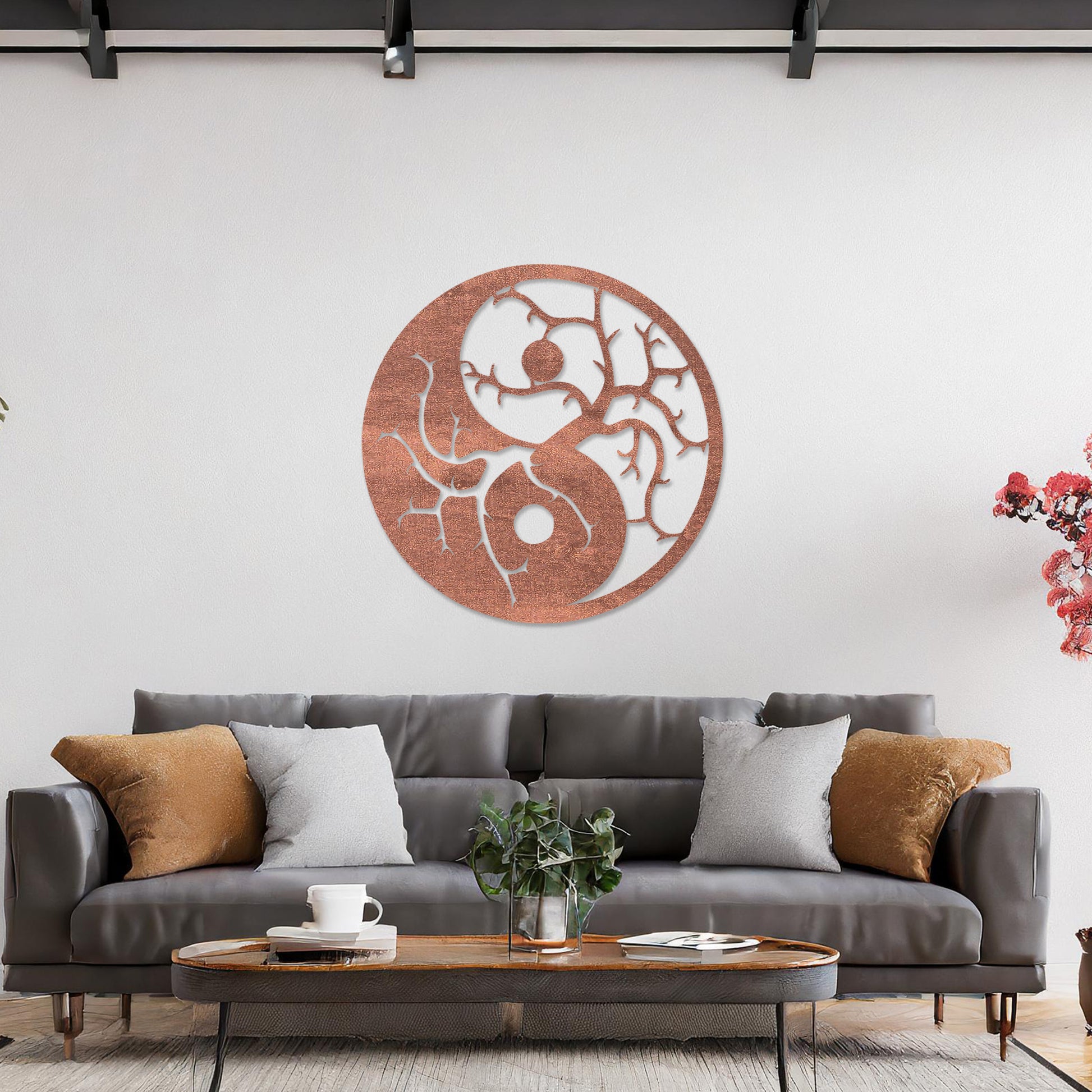 Wall art featuring a yin-yang design with tree branches integrated into each half, symbolising balance and harmony. The piece is displayed on a neutral wall within modern decor, adding a meaningful and artistic focal point to the space.