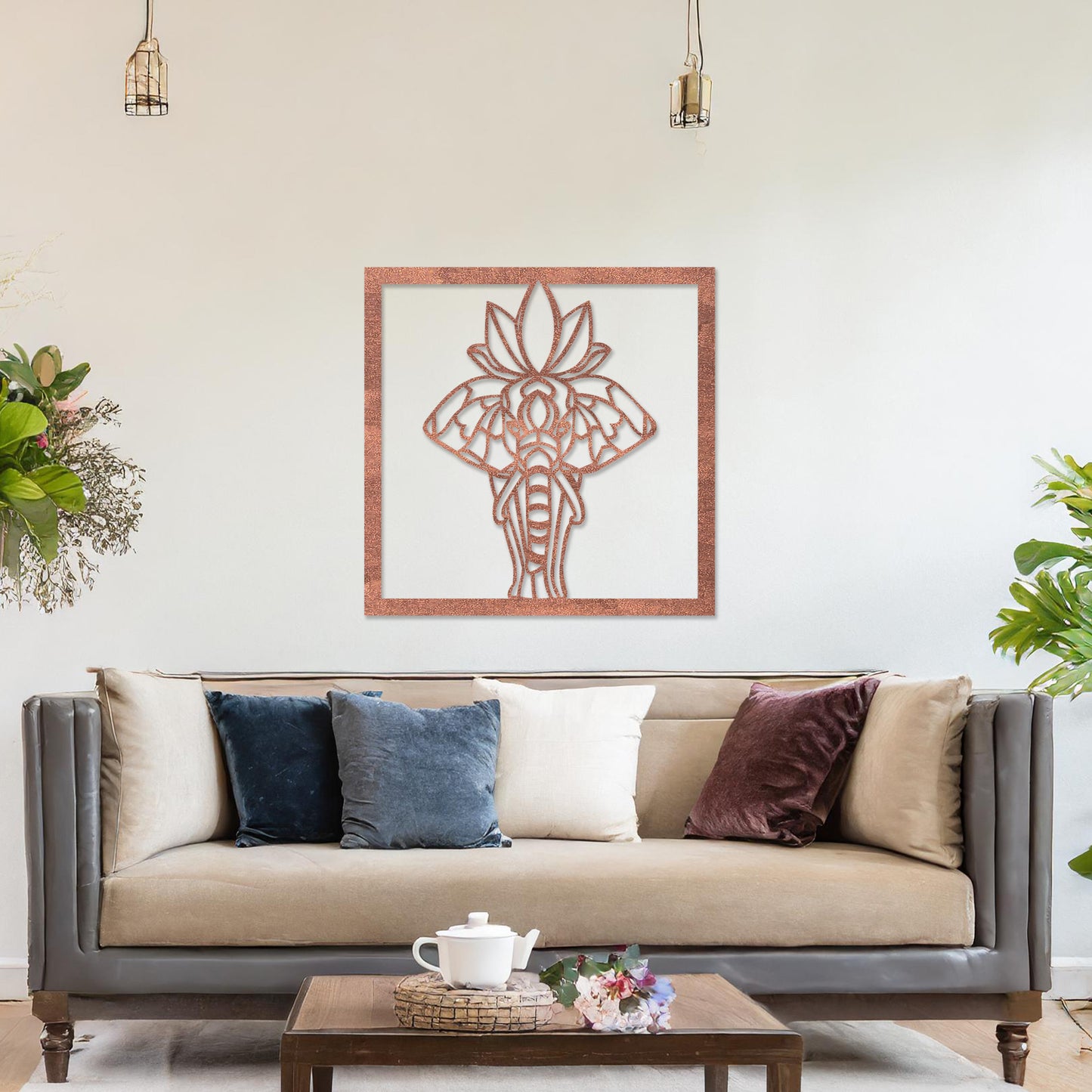 Wooden wall art design featuring an elephant with a lotus flower, framed in a square shape, placed on a neutral wall within modern room decor. The design combines nature and spirituality with delicate lines and intricate details.