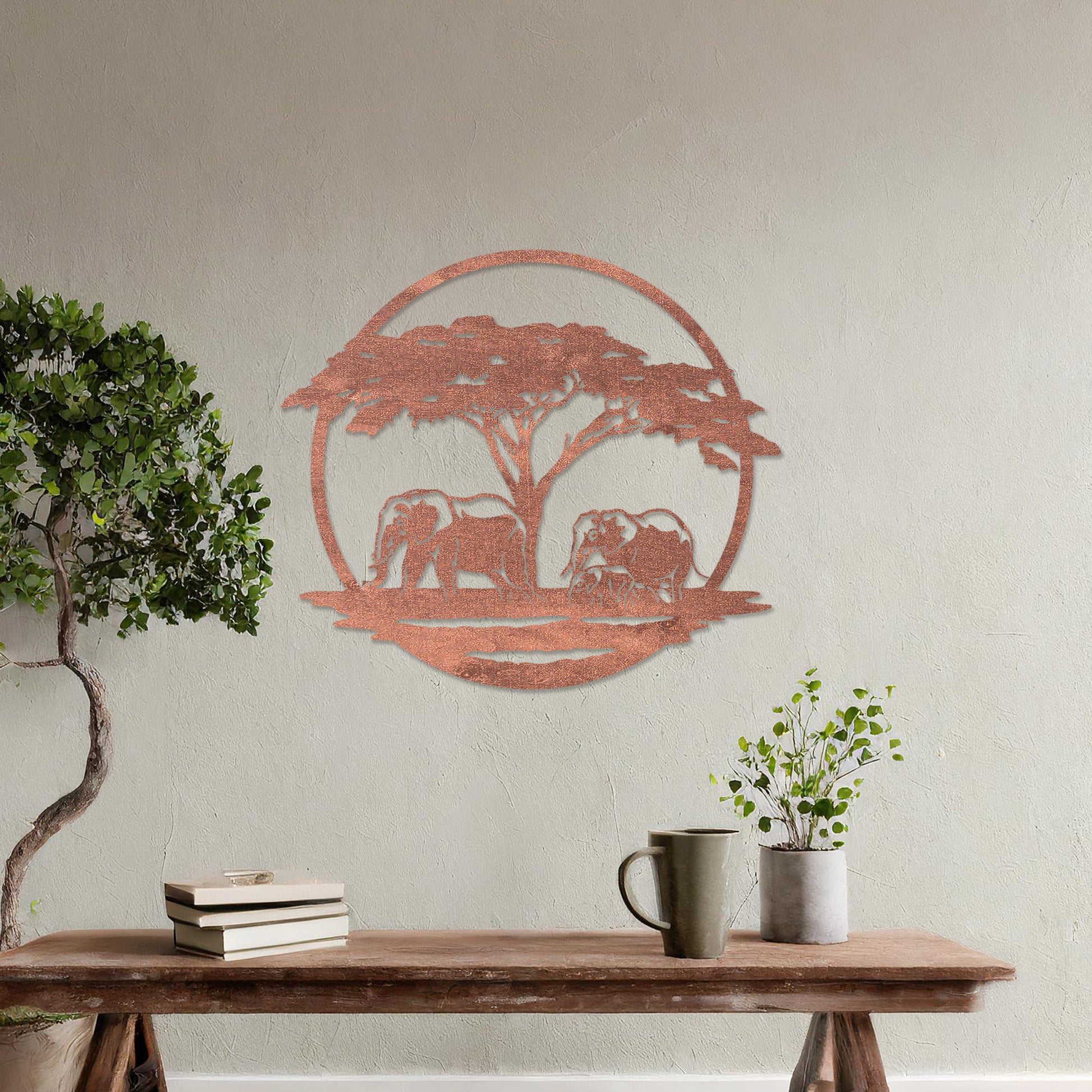 Wooden wall art design featuring two elephants under a tree, framed in a circular shape, placed on a neutral wall within modern room decor. The design evokes a sense of tranquility and nature with its detailed depiction of wildlife.