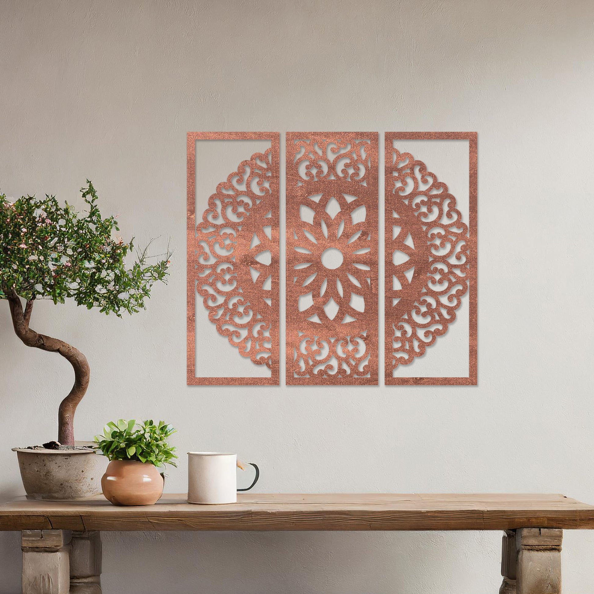 Wall art featuring a triptych design with an intricate mandala pattern framed across three panels. The artwork is displayed on a neutral wall within modern decor, adding a harmonious and decorative element to the space.