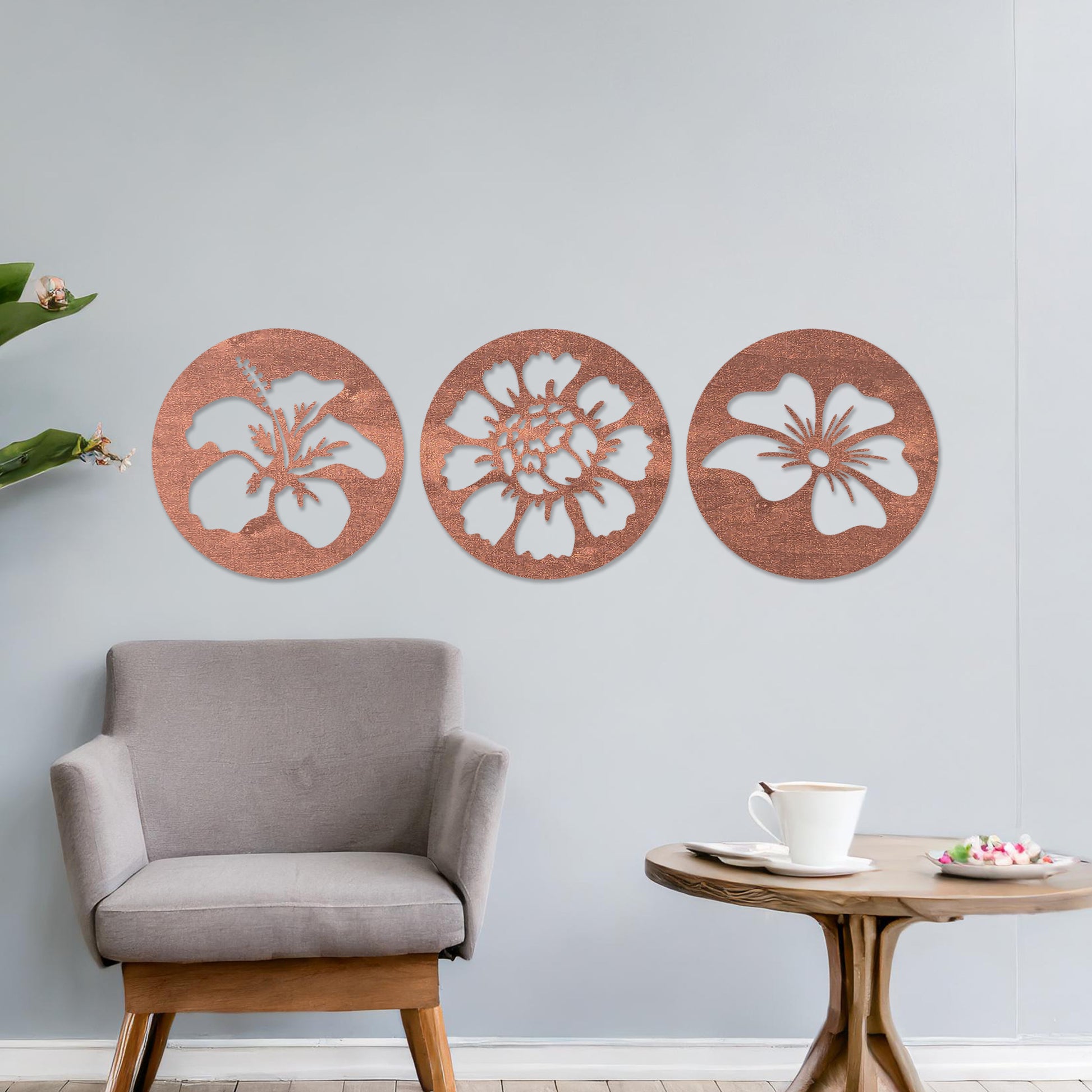 Wall art featuring a set of three circular panels, each showcasing a distinct floral design with intricate cut-out details. The artwork is displayed on a neutral wall within modern decor, adding a charming and decorative touch to the space.