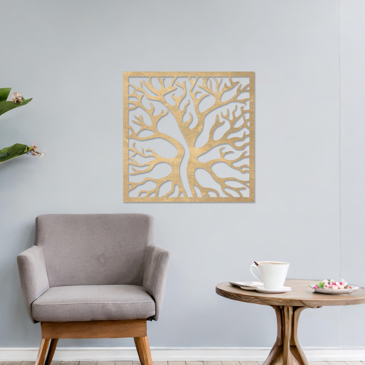 Square wall art featuring a stylised tree with intertwining branches, showcasing a modern and organic design. The artwork is displayed on a neutral wall in a contemporary living room with a sleek sofa and complementary decor.