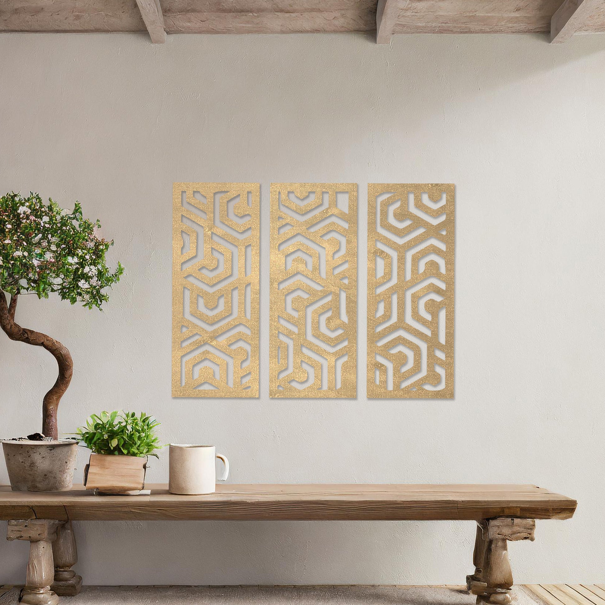 Wooden wall art featuring a three-panel design with intricate geometric patterns. The artwork is displayed on a neutral wall within modern room decor, highlighting its bold and symmetrical design.