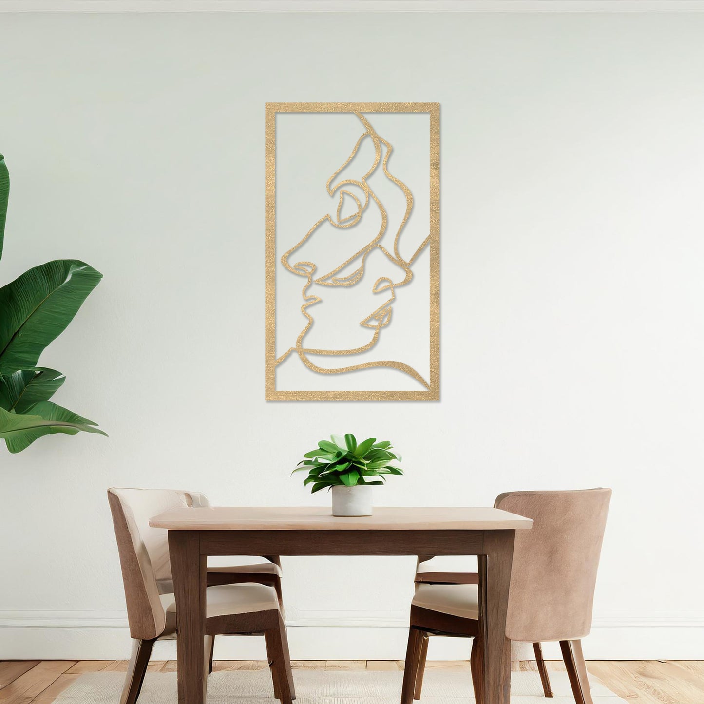 Wooden wall art design featuring abstract line art of two faces, placed on a neutral wall with modern room decor. The design is minimalistic and elegant, capturing human forms through flowing lines.