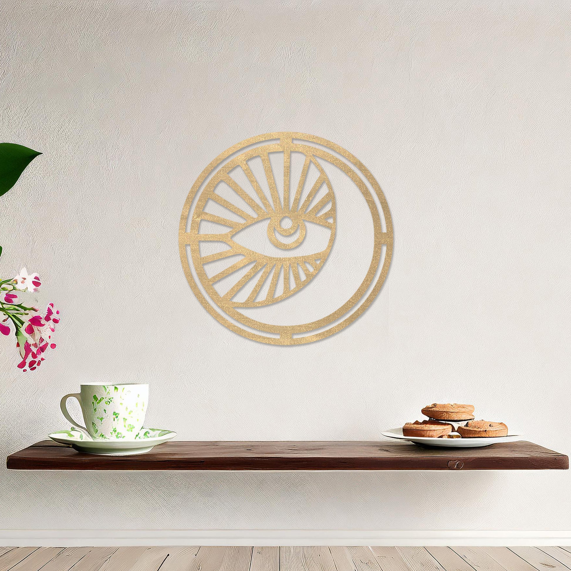 Wooden wall art featuring a circular design with an eye motif and geometric patterns radiating outward. The artwork is displayed on a neutral wall within modern room decor, highlighting its bold and contemporary aesthetic.