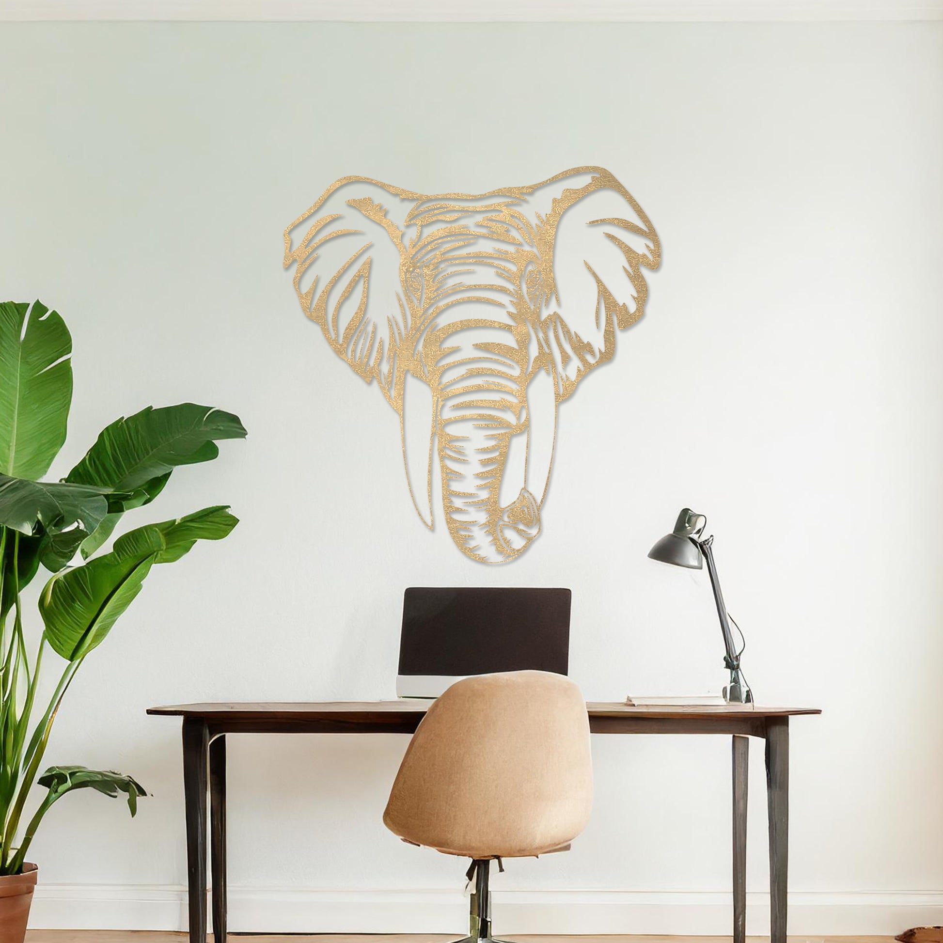 Wooden wall art featuring an intricately detailed elephant head design, displayed on a neutral wall within modern room decor, highlighting its bold and artistic craftsmanship.