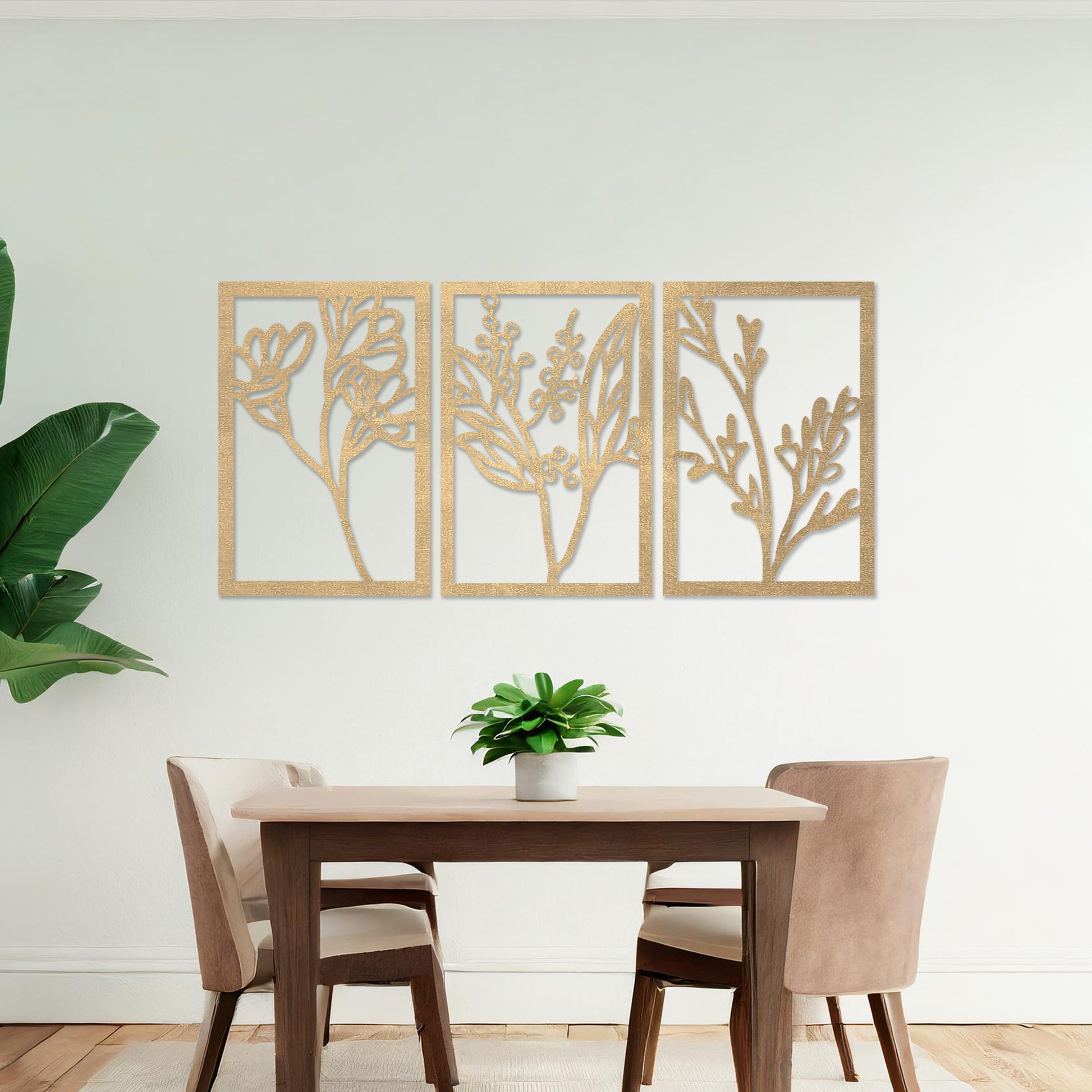 Wall art featuring a triptych of minimalist botanical designs, each panel highlighting delicate stems, leaves, and berries. The artwork is displayed on a neutral wall within modern decor, adding a subtle and natural elegance to the space.