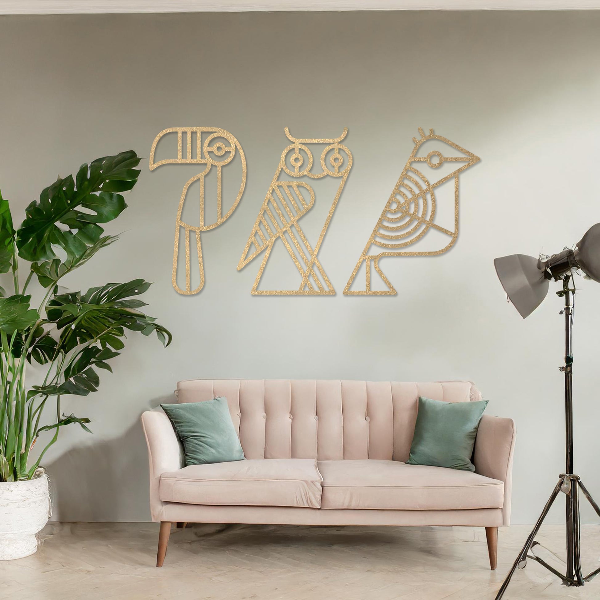 Wooden wall art featuring a trio of abstract geometric bird designs, including a toucan, an owl, and a sparrow. The artwork is displayed on a neutral wall within modern room decor, showcasing its playful and artistic charm.