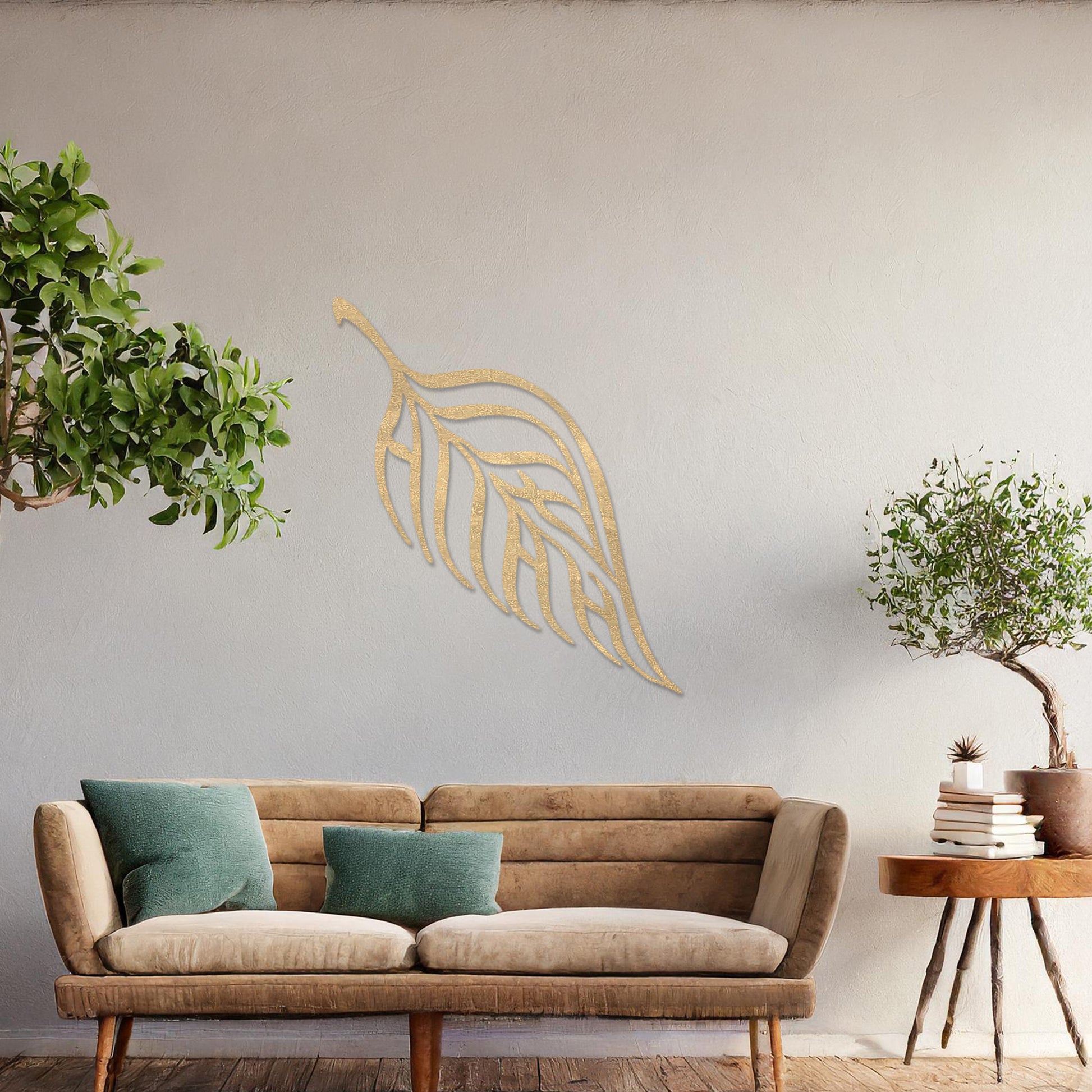 Wooden wall art featuring a single leaf design with elegant, flowing lines and intricate cut-outs. The artwork is displayed on a neutral wall within modern room decor, emphasising its minimalistic and natural aesthetic.