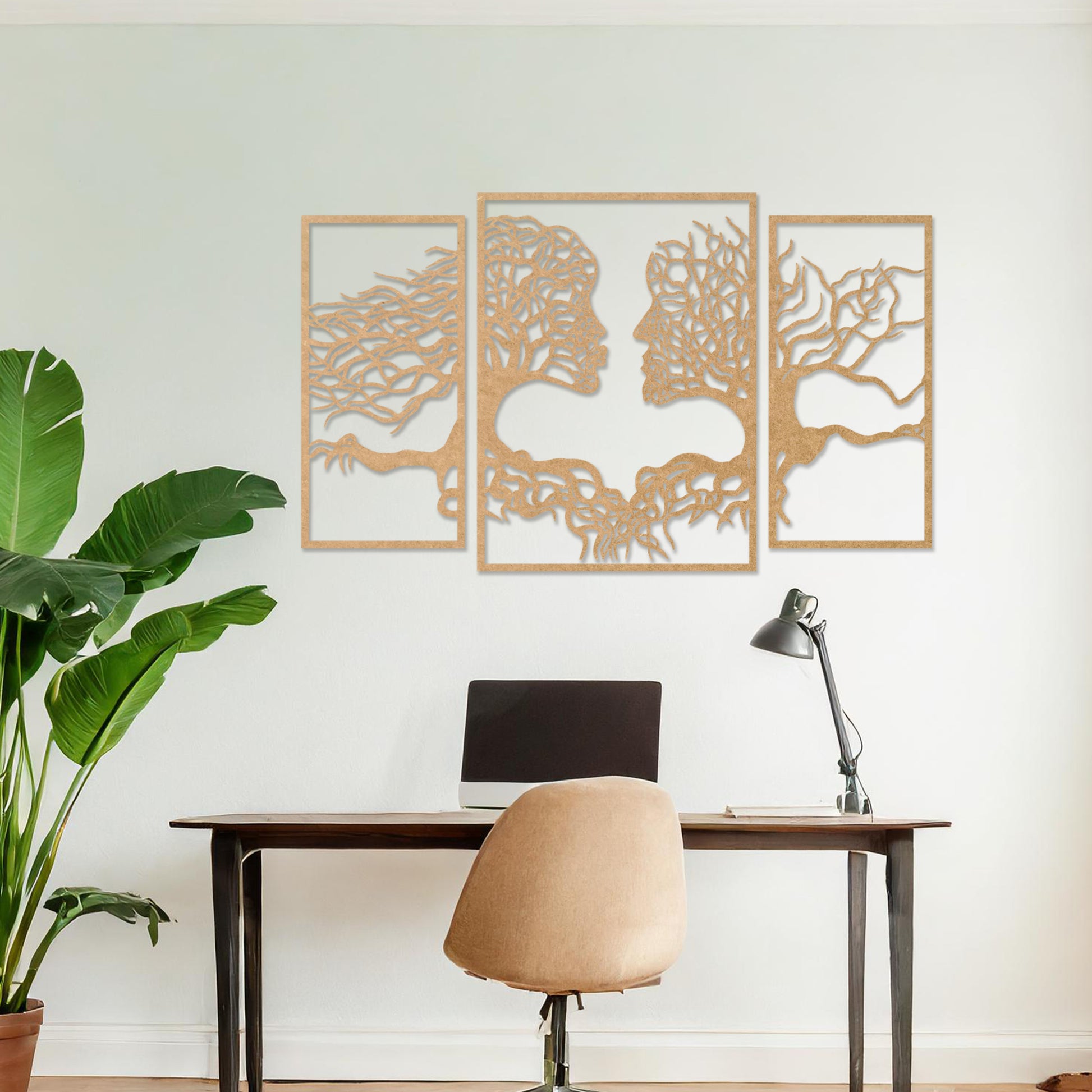 Wooden wall art showcasing a striking design of intertwined tree branches forming human profiles, placed on a neutral wall within modern room decor, highlighting its artistic and symbolic craftsmanship.