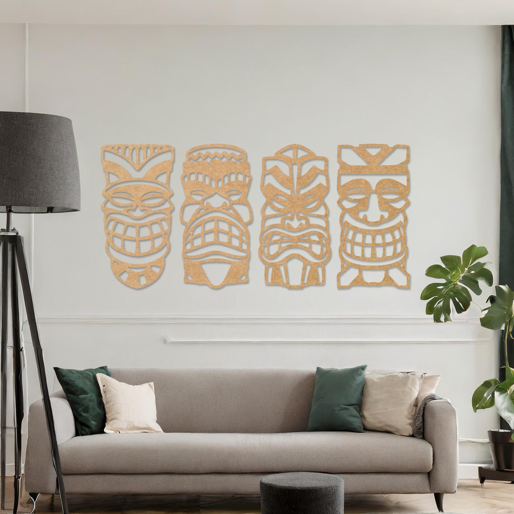 Wooden wall art design featuring four tribal masks arranged in a row on a neutral wall, set against modern room decor. The intricate design captures bold, expressive features and cultural motifs.