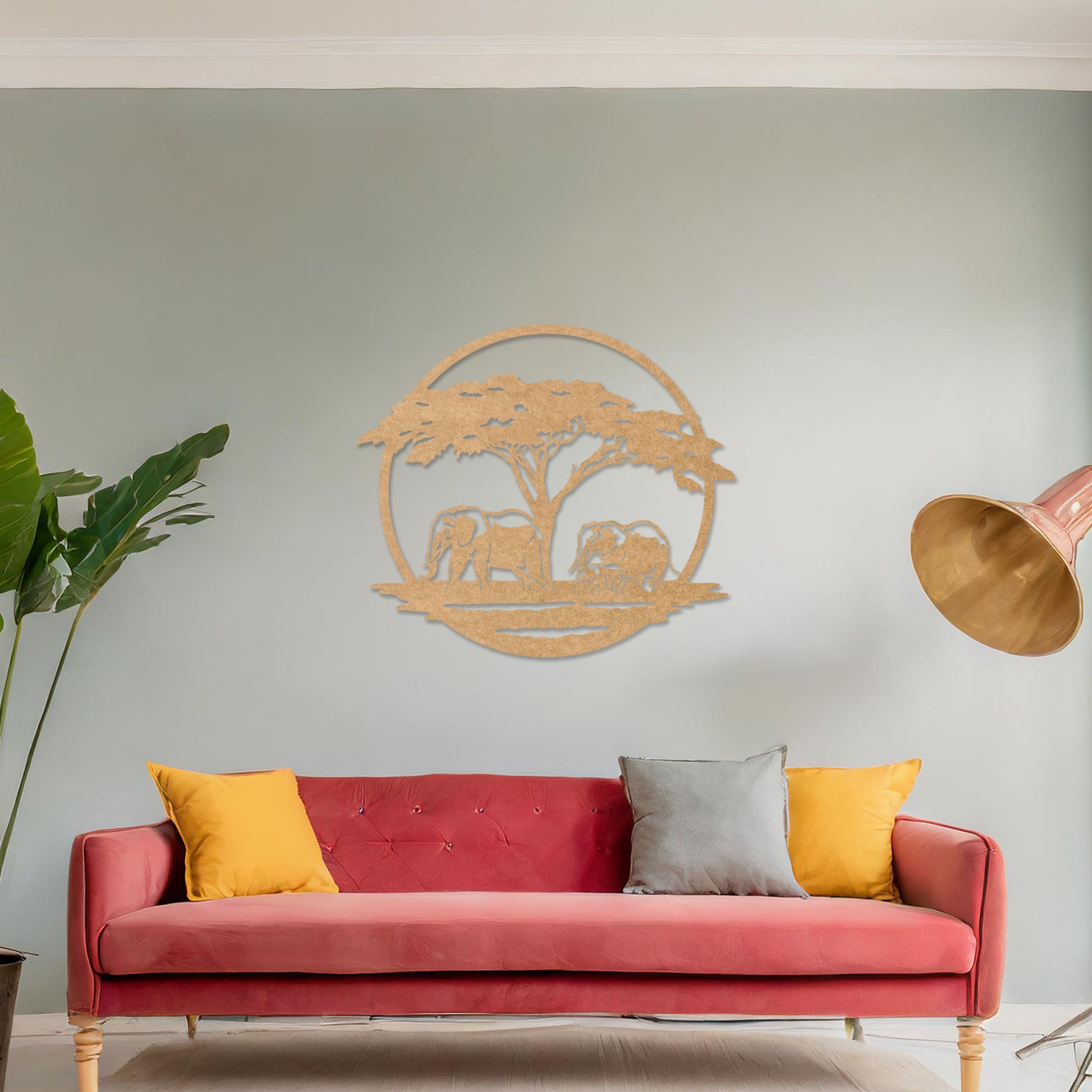 Wooden wall art design featuring two elephants under a tree, framed in a circular shape, placed on a neutral wall within modern room decor. The design evokes a sense of tranquility and nature with its detailed depiction of wildlife.