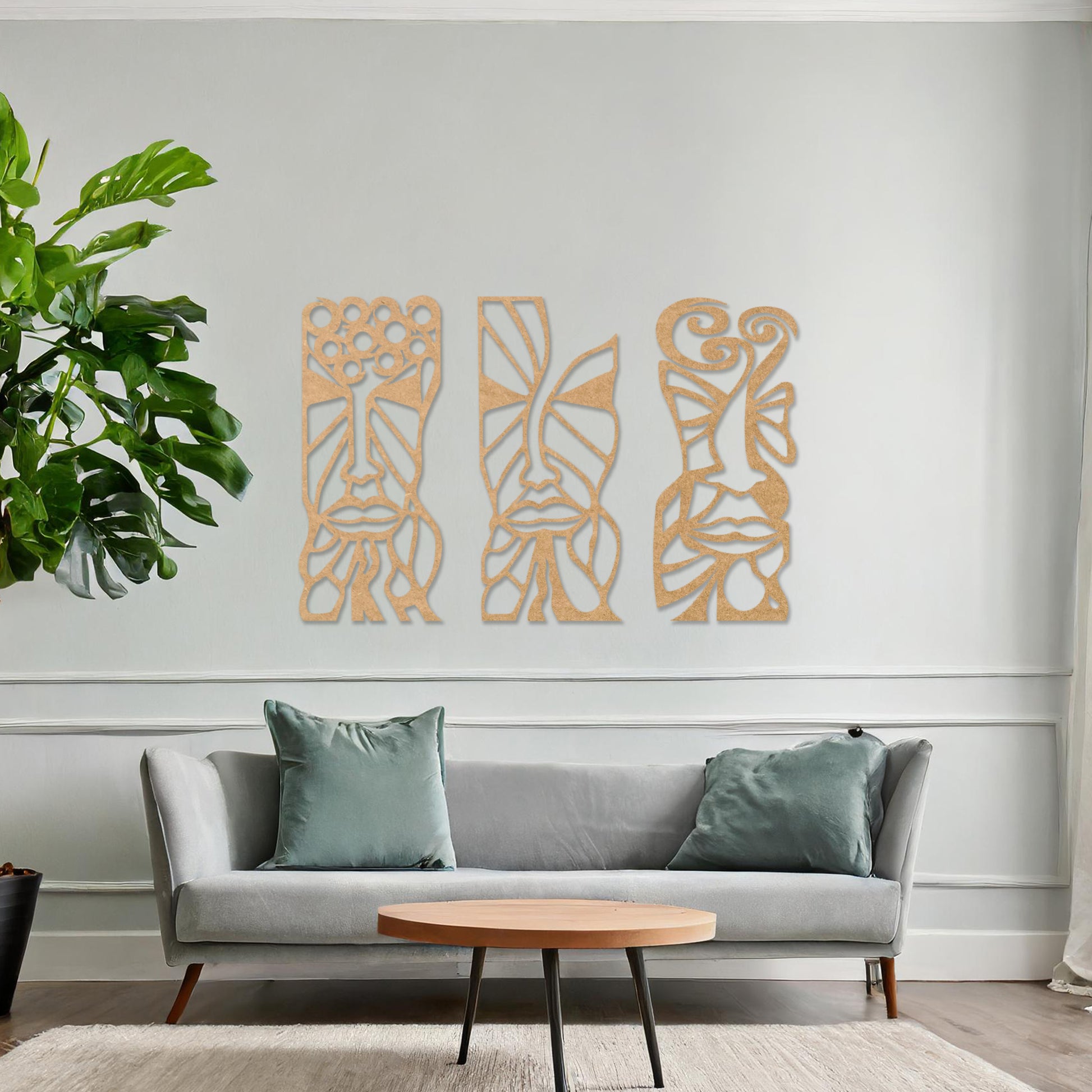 Wooden wall art set featuring three abstract face designs with intricate geometric and flowing patterns, displayed on a neutral wall within modern room decor, highlighting their artistic and contemporary appeal.