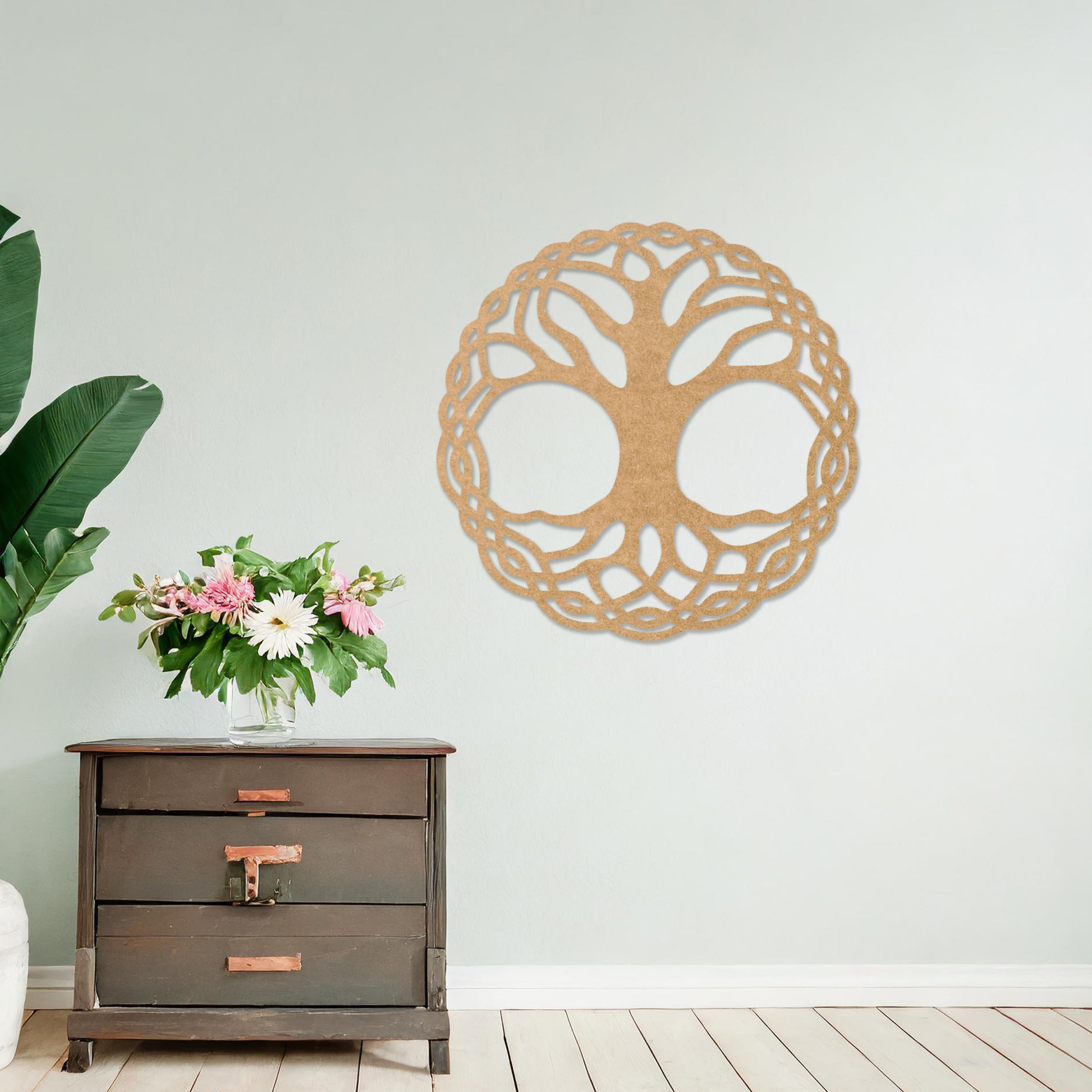 Wooden wall art depicting a circular tree of life design with intertwined roots and branches, placed on a neutral wall within a modern room decor, highlighting its intricate craftsmanship and symbolic aesthetic.