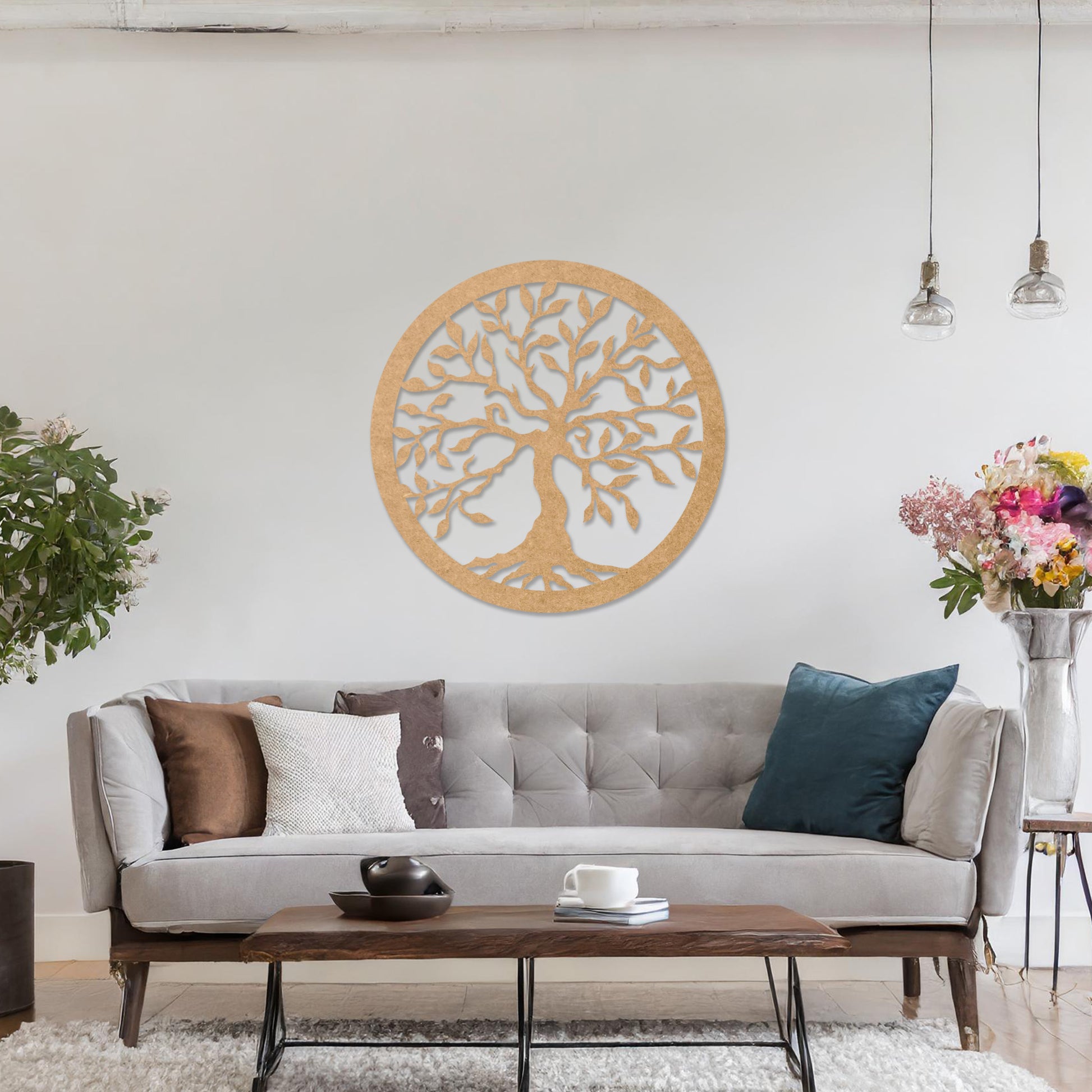 Round wooden wall art featuring an intricately designed tree with sprawling branches and delicate leaves, placed on a neutral wall within a modern setting. The art adds a natural and stylish focal point to the room.