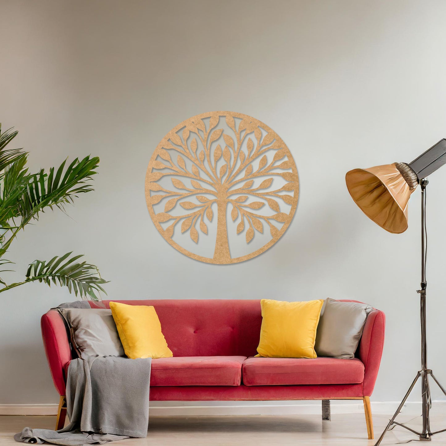 Wooden wall art featuring a circular tree design with stylised leaves and branches, displayed on a neutral wall within modern room decor, highlighting its elegant and nature-inspired craftsmanship.