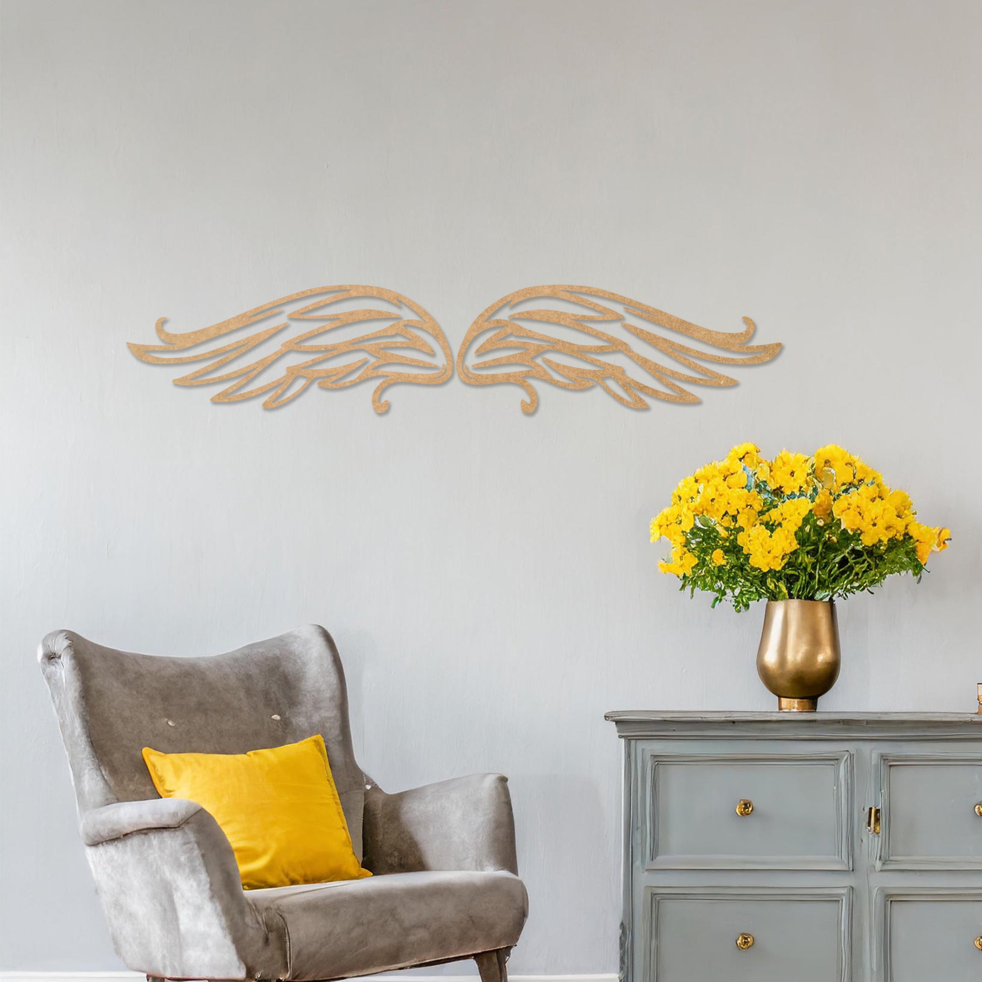 Wall art featuring a pair of intricately designed angel wings with flowing lines and graceful curves. The piece is displayed on a neutral wall within modern decor, adding a symbolic and elegant touch to the setting.