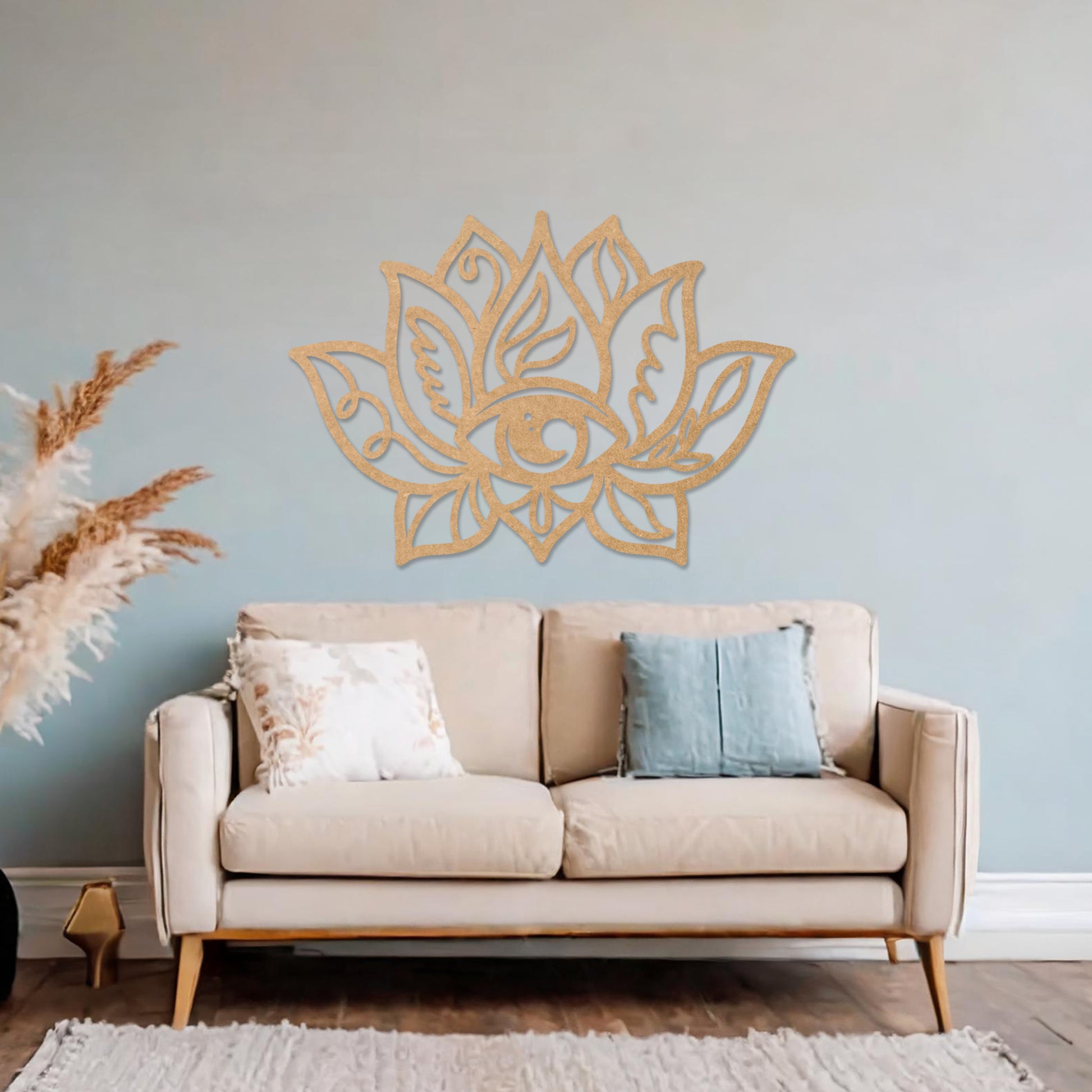 Wooden wall art featuring a lotus flower design with an eye motif at its centre and intricate detailing. The artwork is displayed on a neutral wall within modern room decor, highlighting its symbolic and artistic appeal.