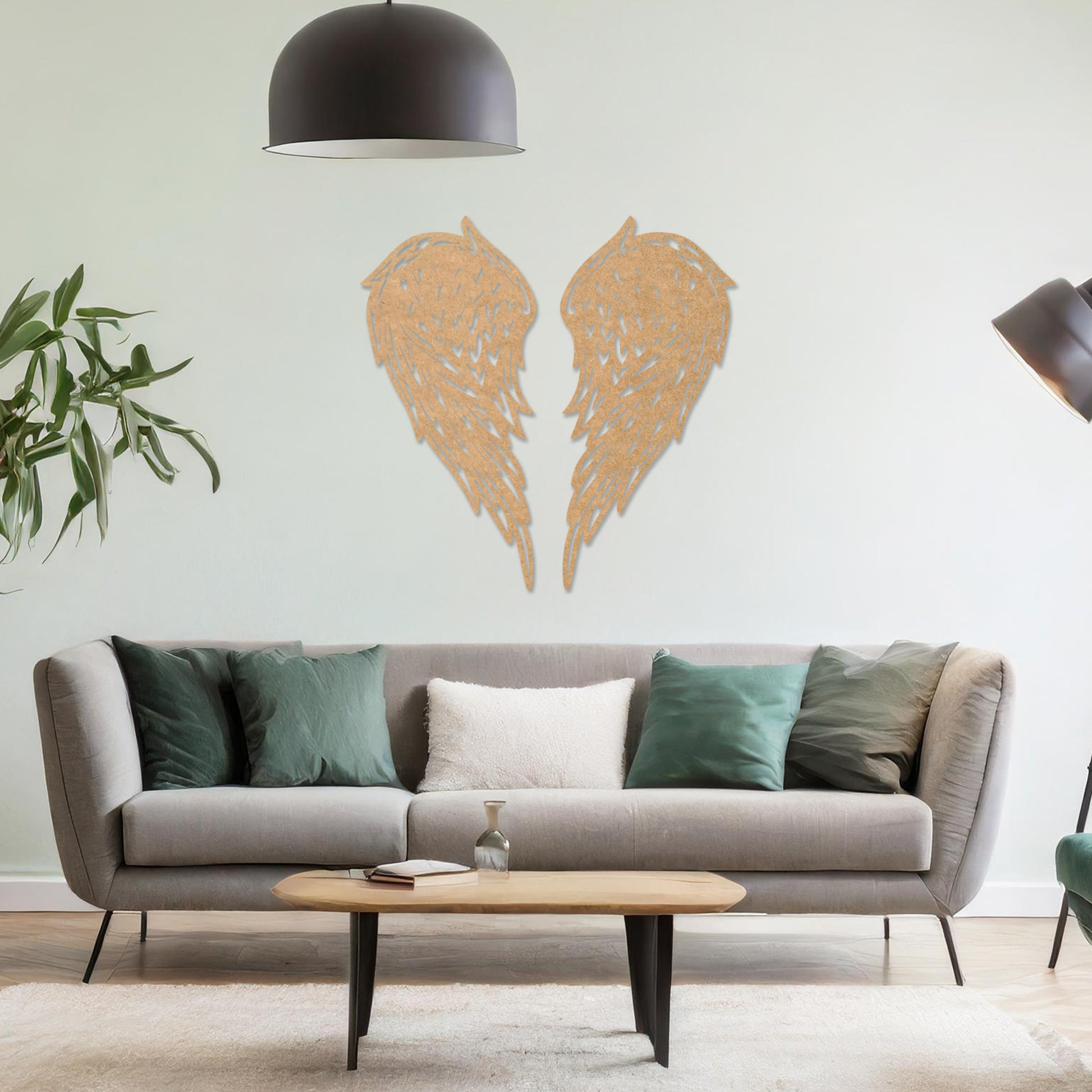 Wall art showcasing intricately designed angel wings with detailed feather patterns, displayed on a neutral wall in a modern living room. The piece adds a sense of elegance and serenity to the contemporary decor.