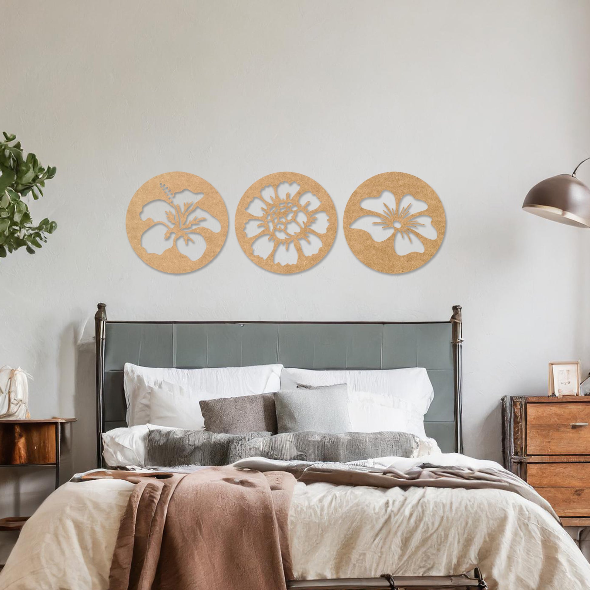 Wall art featuring a set of three circular panels, each showcasing a distinct floral design with intricate cut-out details. The artwork is displayed on a neutral wall within modern decor, adding a charming and decorative touch to the space.