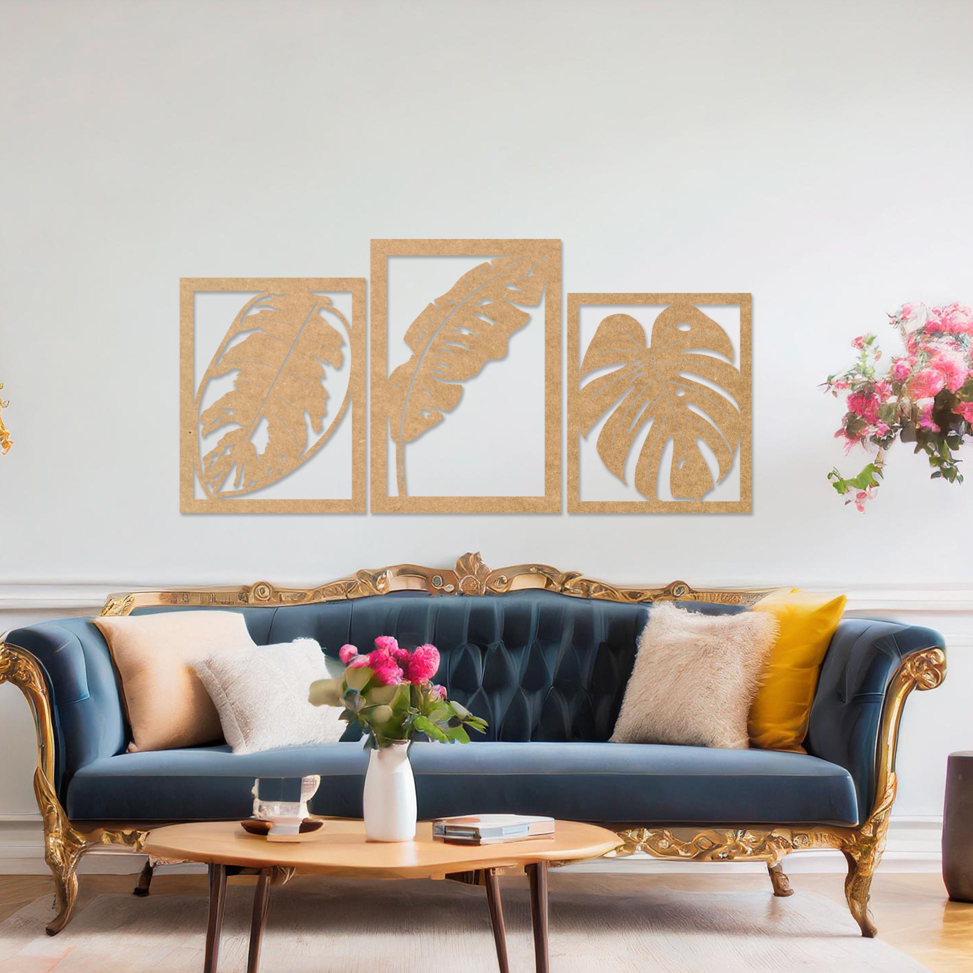 A three-piece wall art set featuring artistic depictions of tropical leaves, including monstera and banana leaves, framed in a rectangular layout. The artwork is displayed on a neutral wall in a modern room