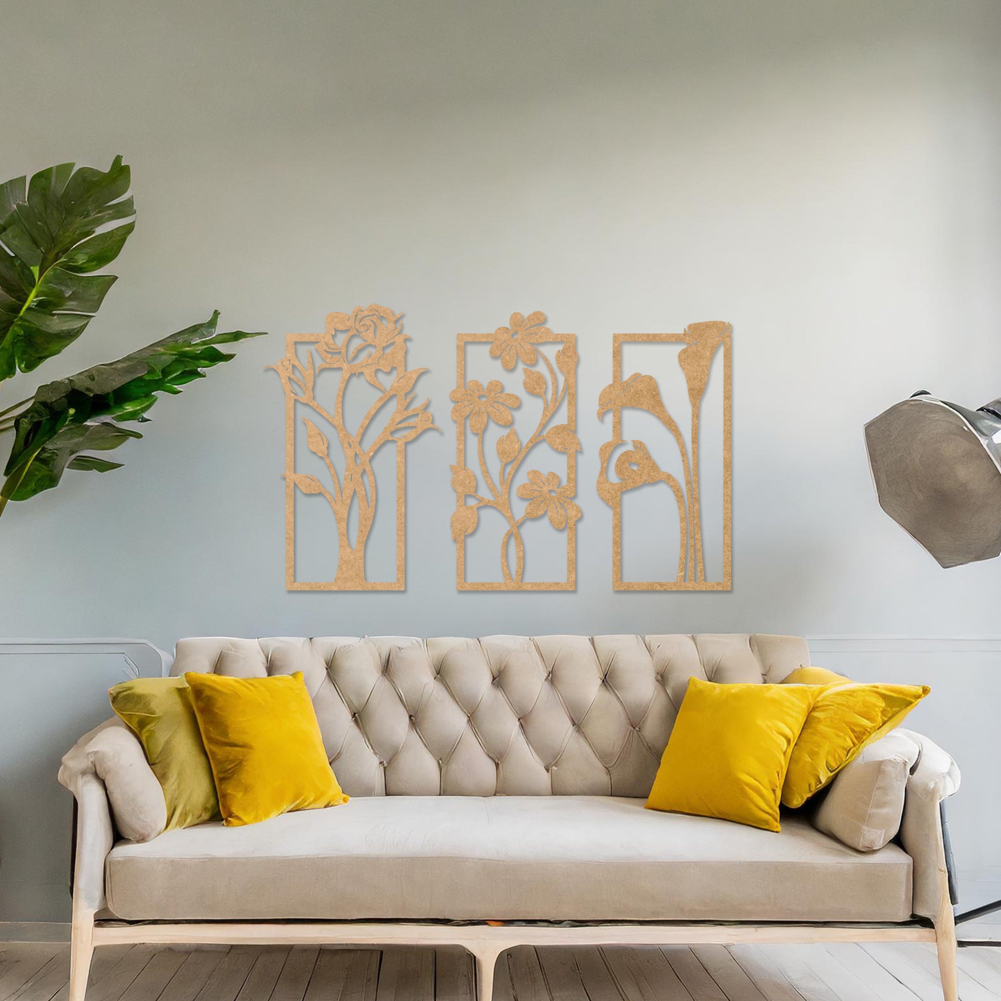 Wall art featuring a triptych of floral designs, each panel showcasing distinct flowers such as roses, daisies, and calla lilies. The artwork is displayed on a neutral wall within modern decor, adding a natural and elegant touch to the space.