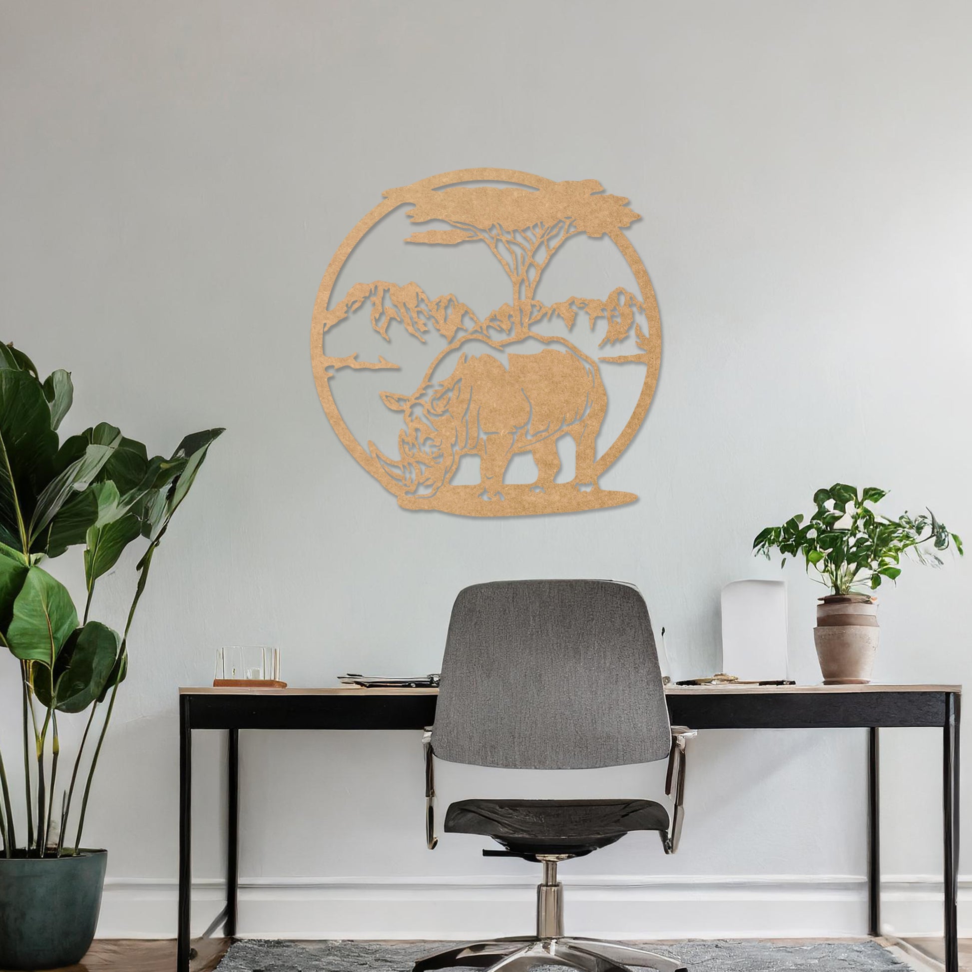 Wooden wall art design featuring a rhinoceros beneath a tree with a mountain backdrop, framed in a circular shape, placed on a neutral wall within modern room decor. The design captures the majesty of wildlife in a serene landscape.