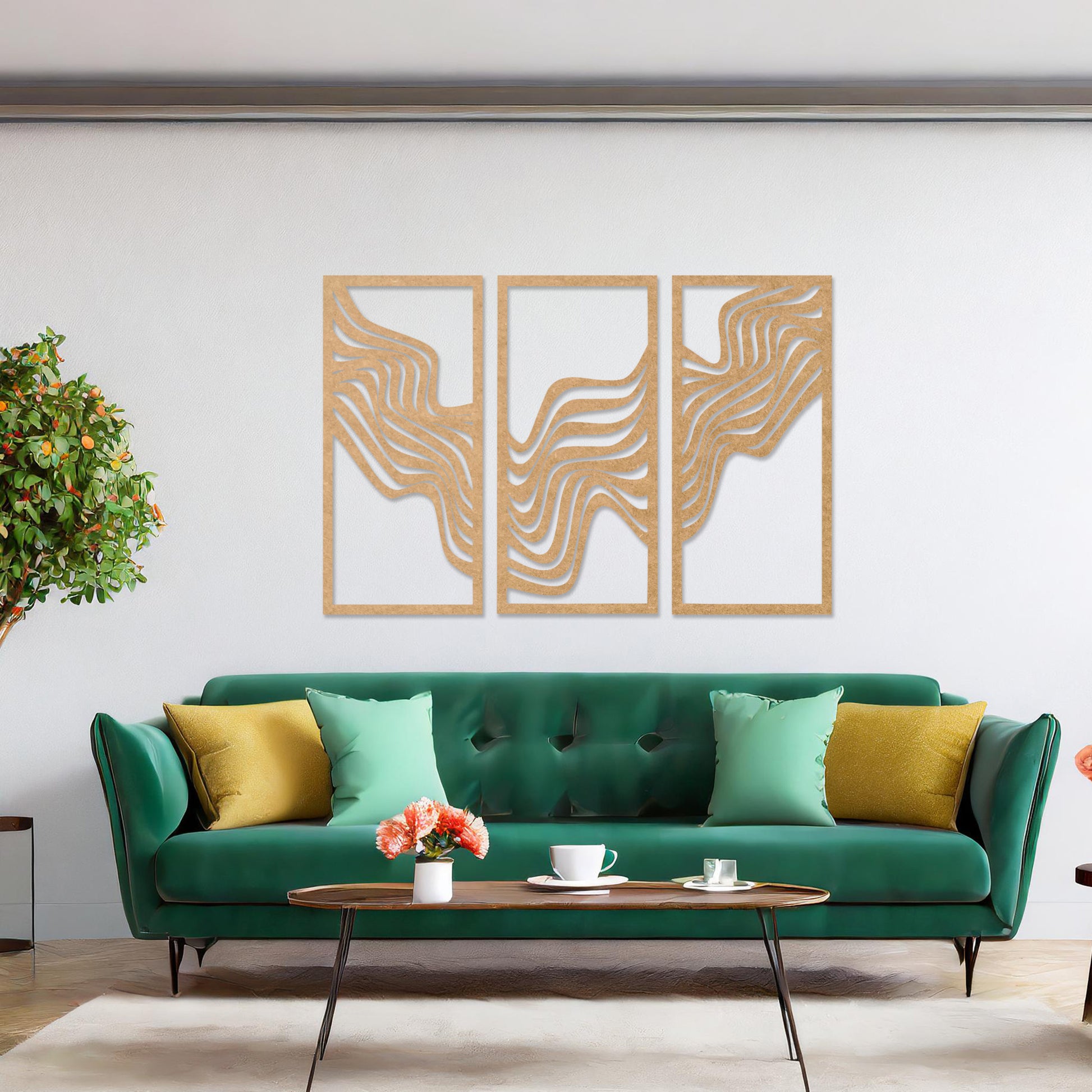 This image displays a modern triptych wall art design featuring flowing wave-like lines. The abstract patterns create a dynamic and visually appealing composition, adding an elegant touch to the living room's decor, complemented by a colourful sofa and floor lighting.